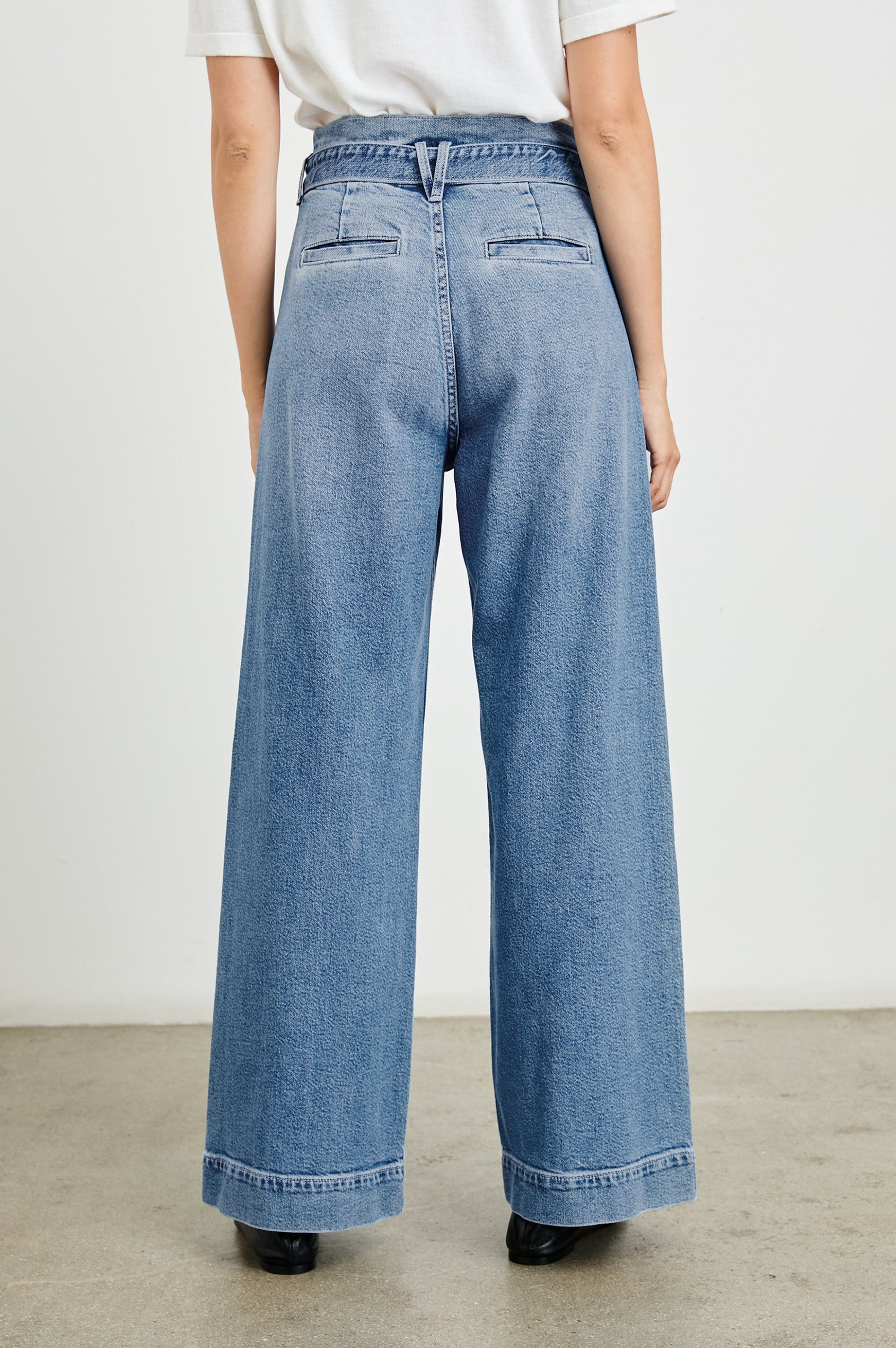 Descanso Wide Leg Denim Pants with Belt Loops, a Fabric O-Ring Belt, Two Front Pockets Plus a Coin Pocket and Two Back Patch Pockets in Cadet Blue Colorway - Back View Featured on Model