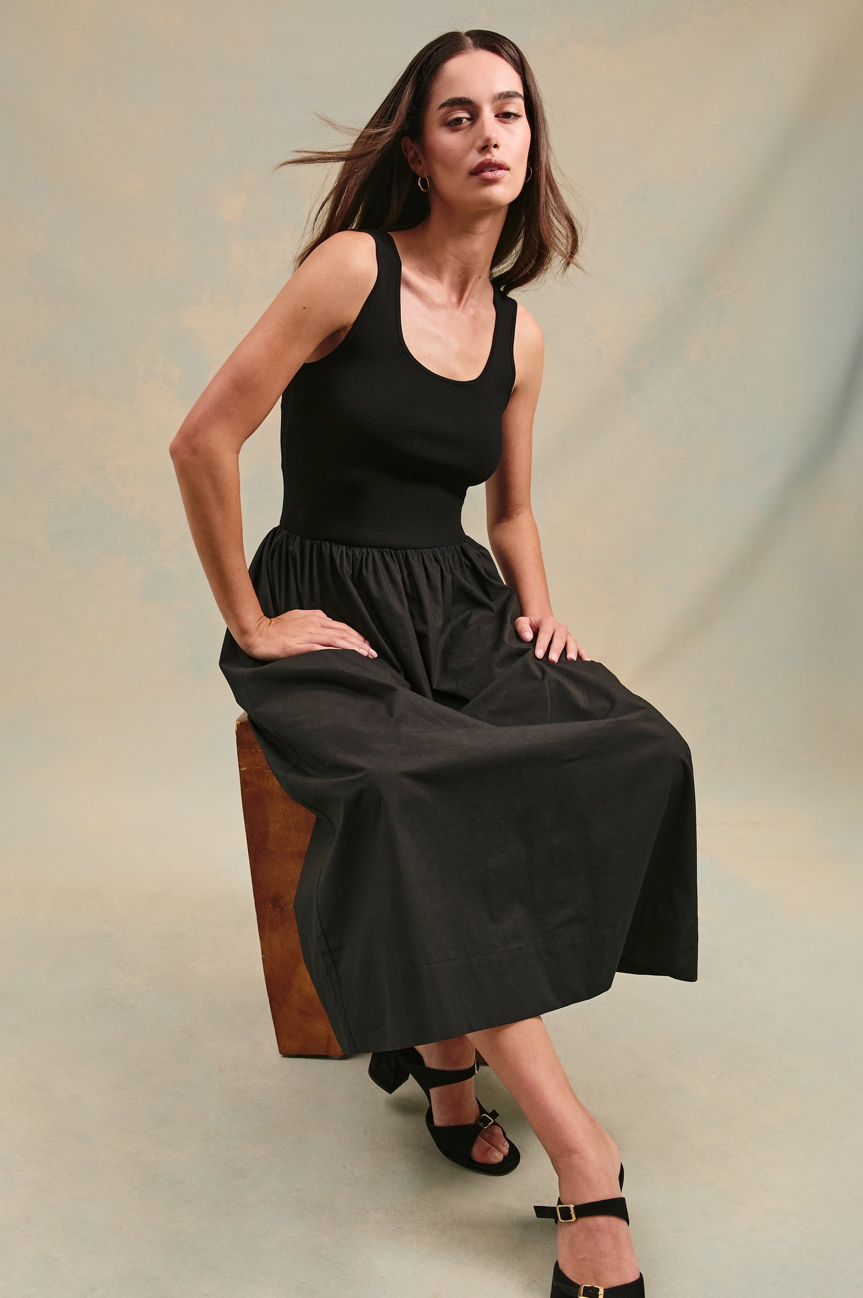 Dia tank midi dress with scoop neck and fitted bodice in Black - stylized view on model sitting down