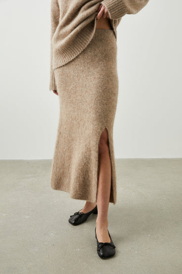 Diana Midi Skirt with a Side Slit and a Ribbed Waist in Oatmeal Colorway - Front View Featured on Model 