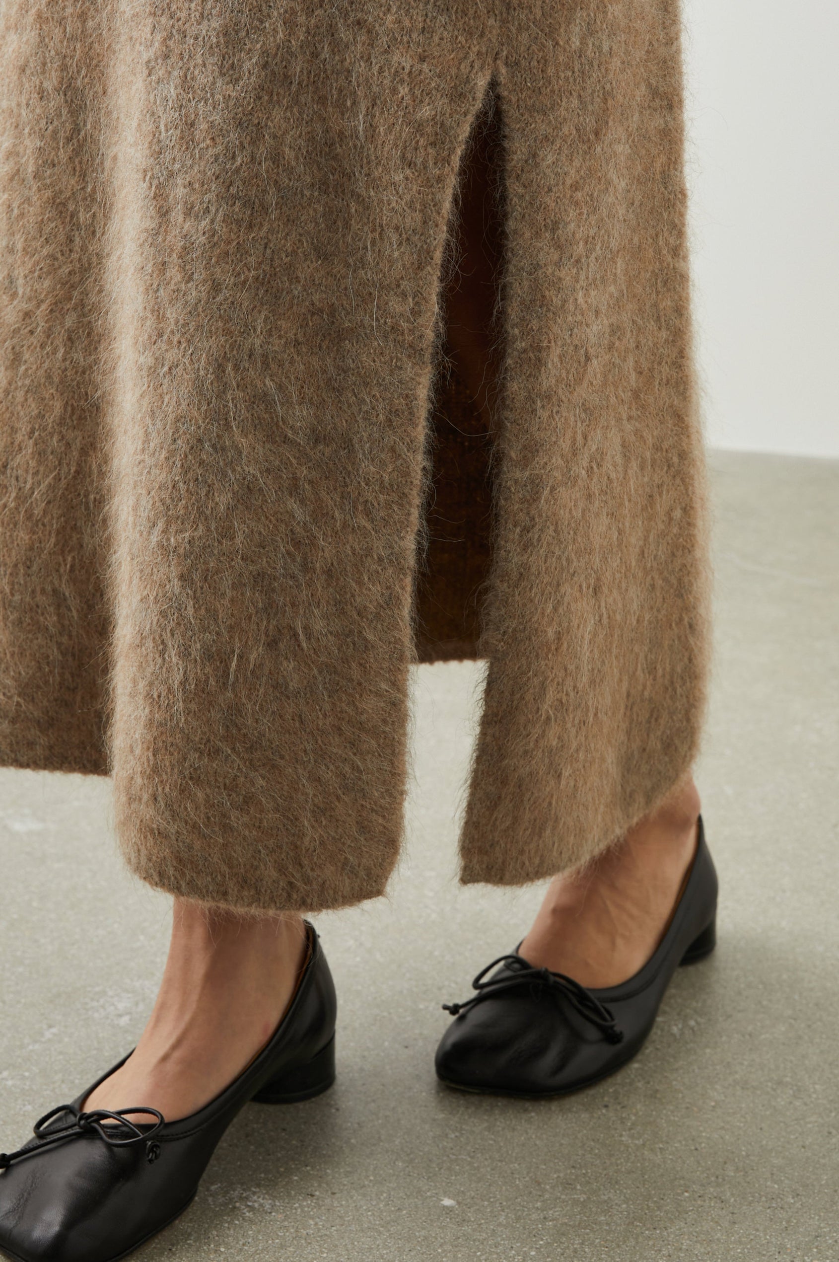 Diana Midi Skirt with a Side Slit and a Ribbed Waist in Oatmeal Colorway - Front View Featured on Model 