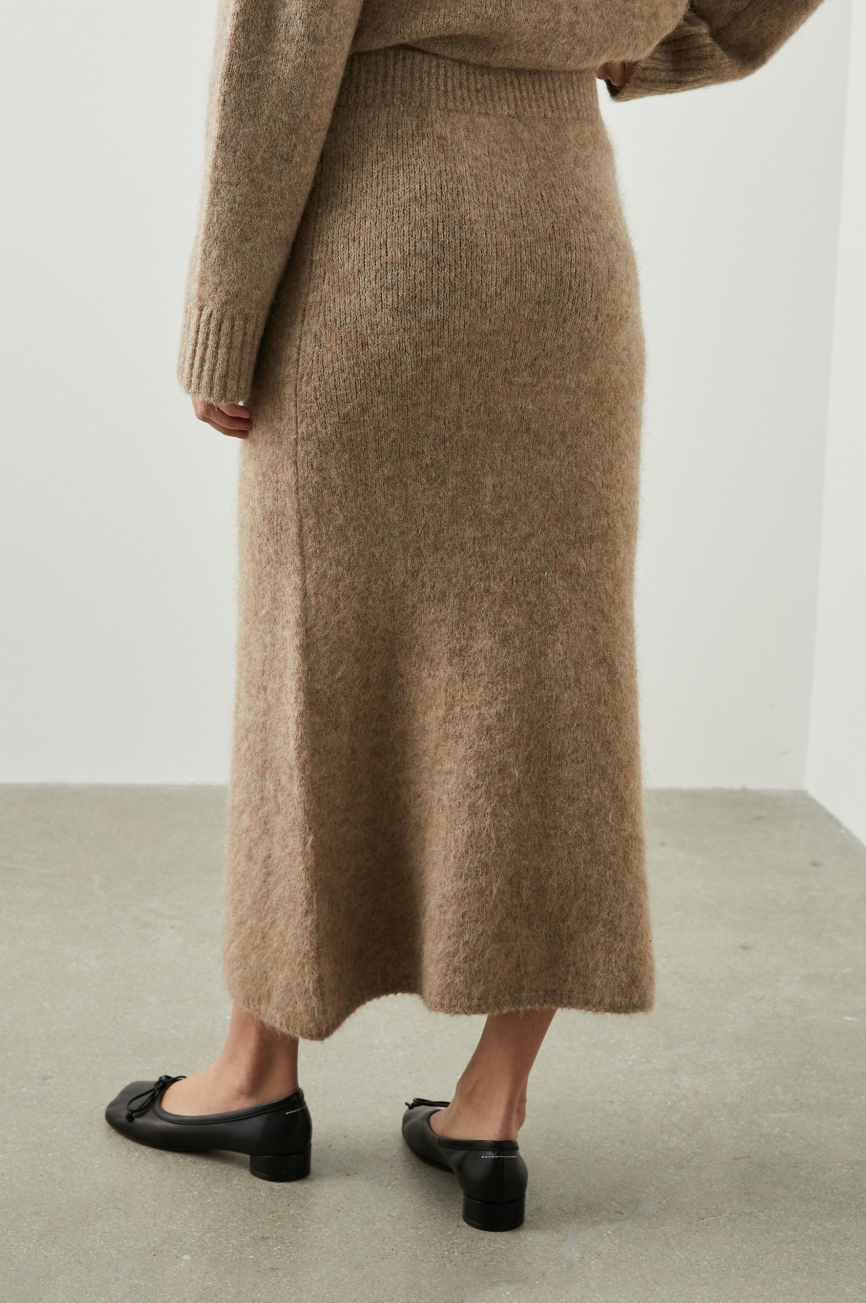 Diana Midi Skirt with a Side Slit and a Ribbed Waist in Oatmeal Colorway - Back View Featured on Model 