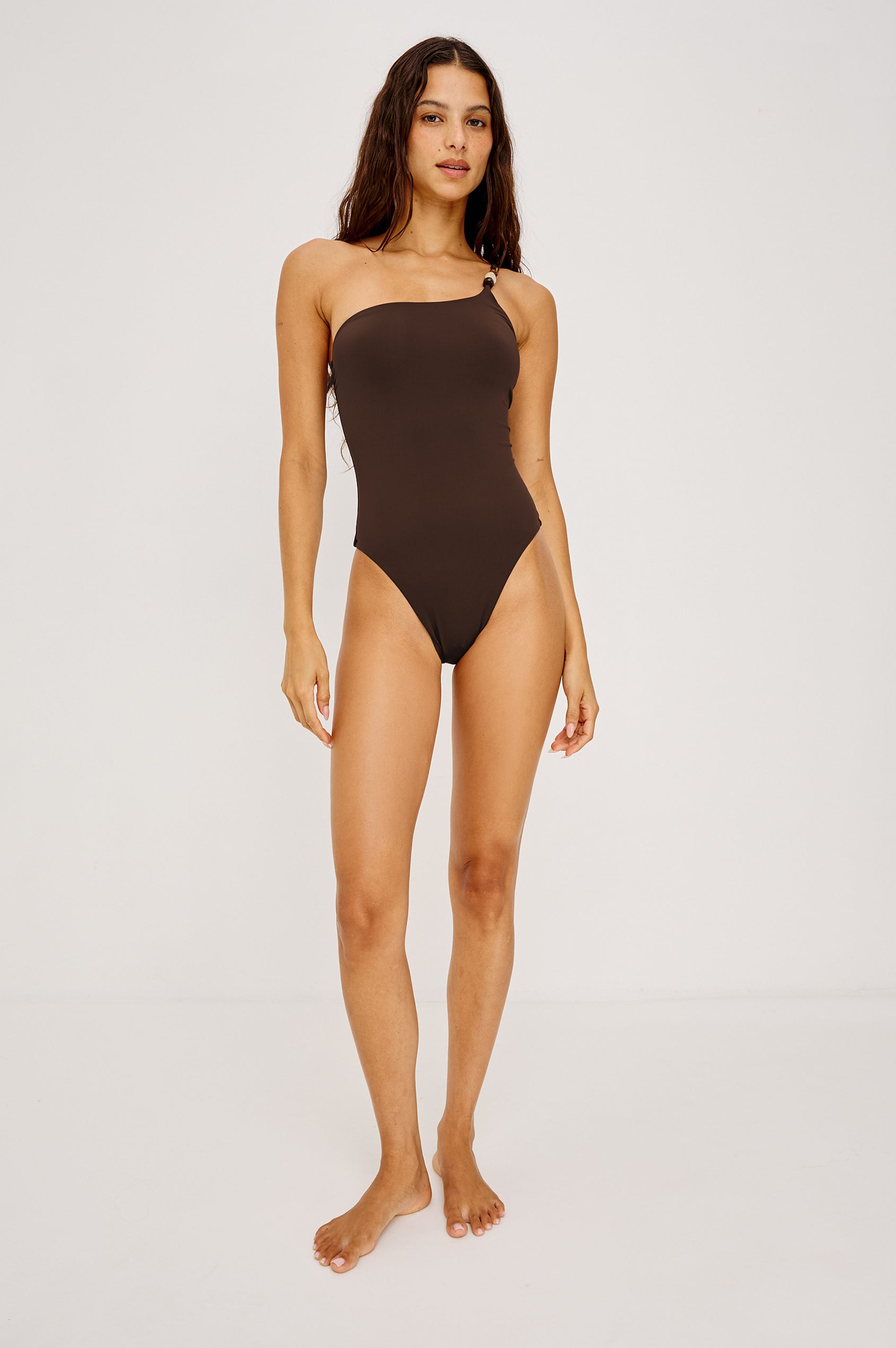 Diani One Piece Swimsuit With One-Shoulder Beaded Strap, High-Cut Legs, and Cheeky Rear Coverage in Espresso Colorway - Full Body Front View Featured on Model