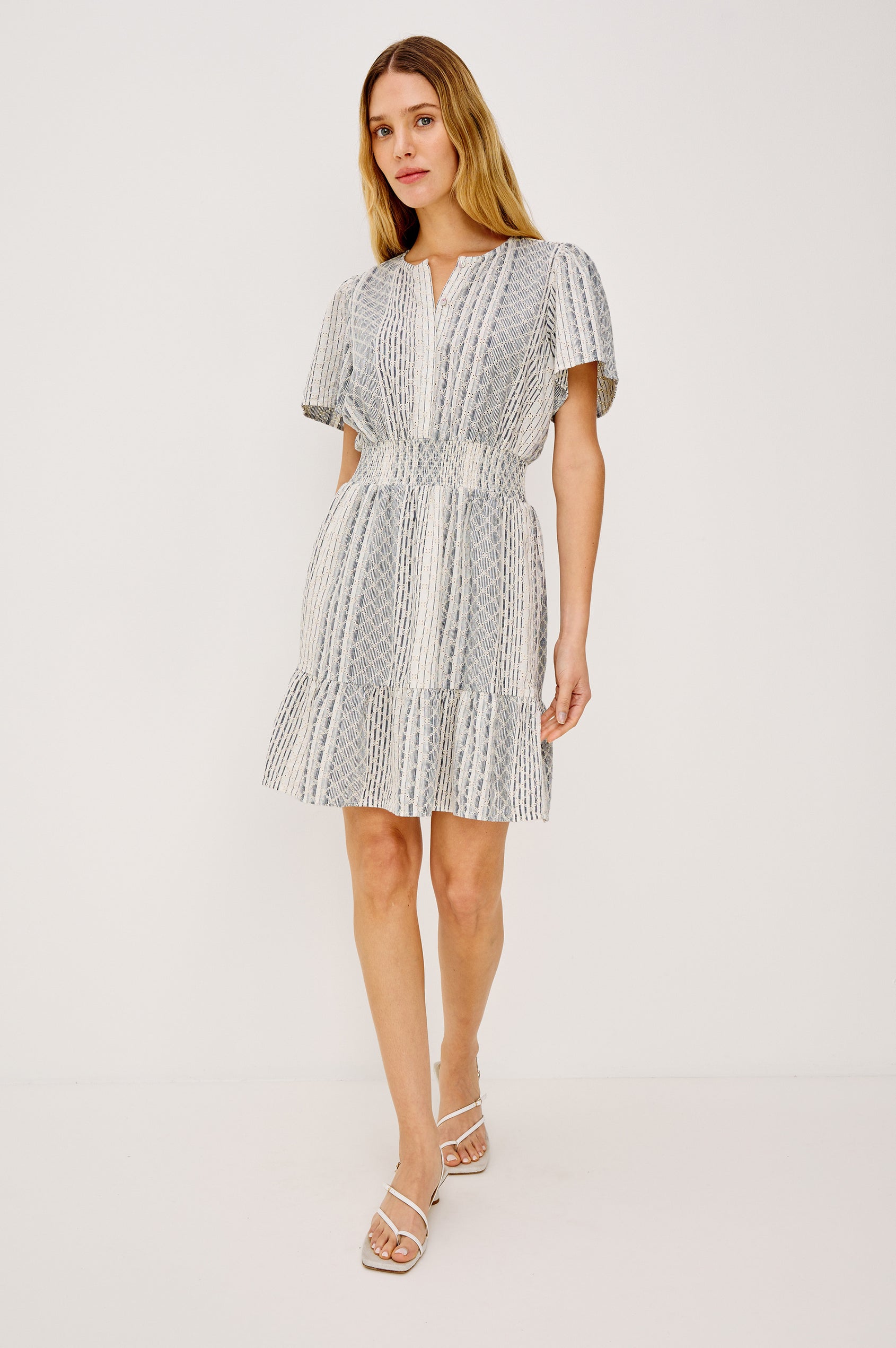 Didi Peasant Style Mini Dress in Luxe Linen With Front Button Placket, Smocked Waist, and Tiered Hem in Striped Eyelet Colorway - Full Body Front View Featured on Model