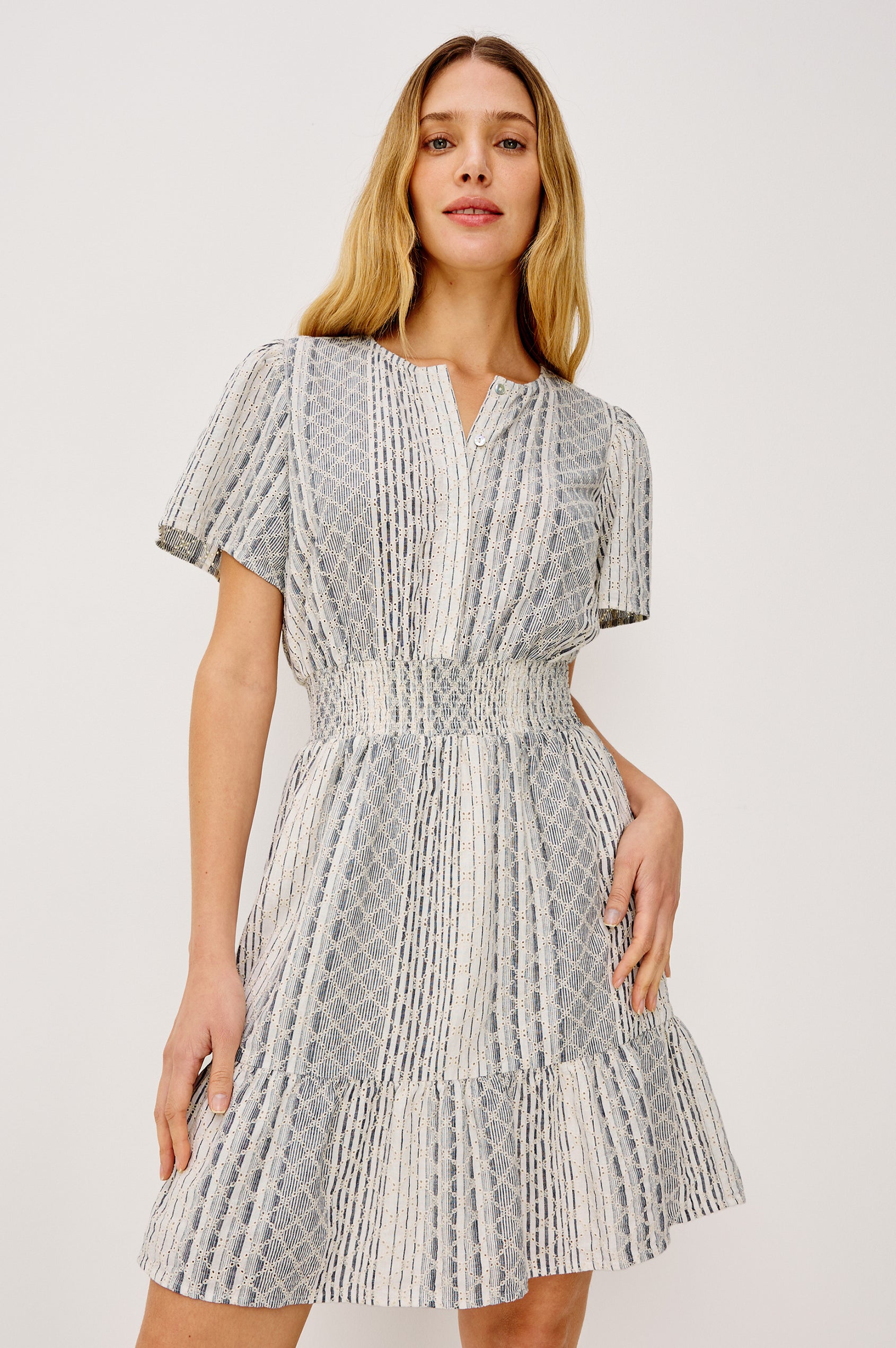 Didi Peasant Style Mini Dress in Luxe Linen With Front Button Placket, Smocked Waist, and Tiered Hem in Striped Eyelet Colorway - Upper Body Front View Featured on Model