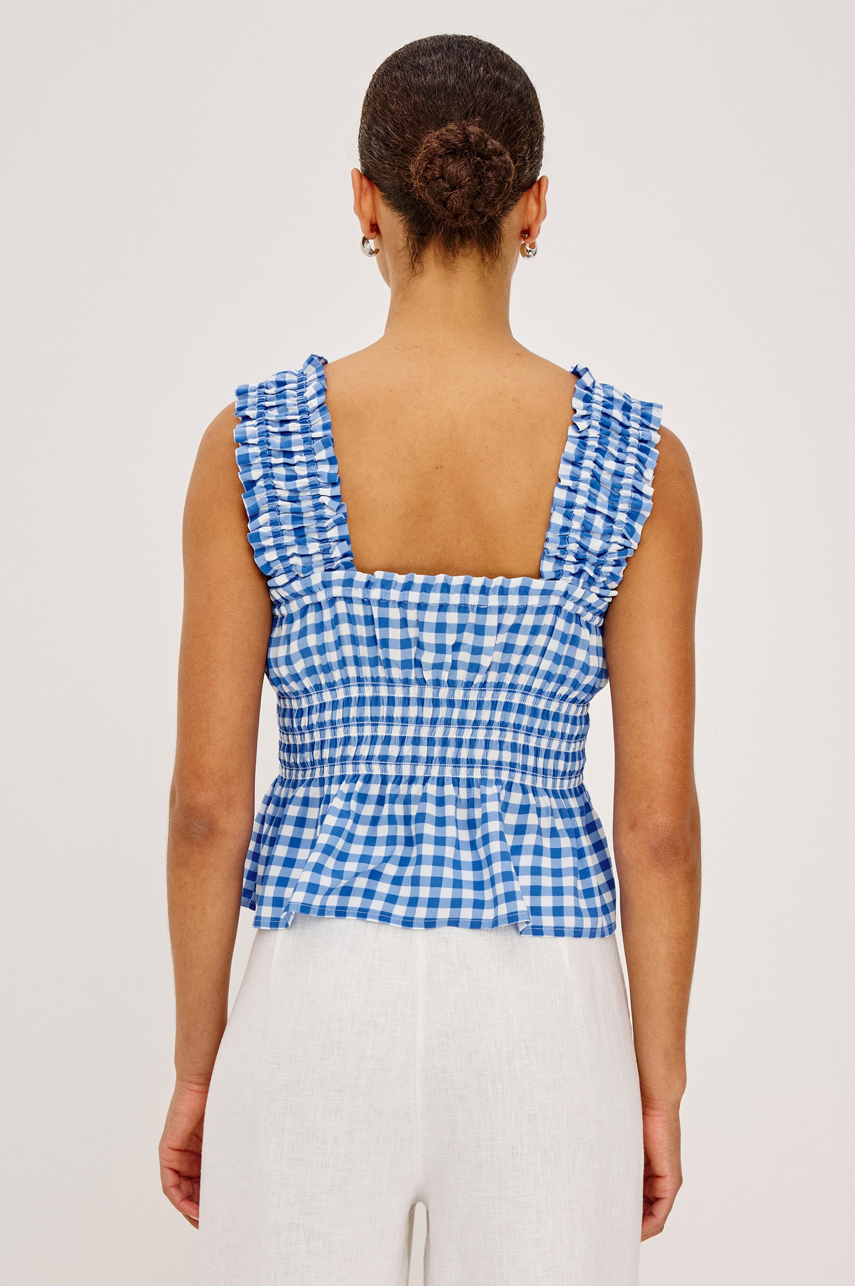 Donna Top With Square Neckline, Smocked Shouolder Straps, Center-Front Bust Ties, Smocked Waist, and Peplum Hem in Azure Gingham Colorway - Upper Body Back View Featured on Model