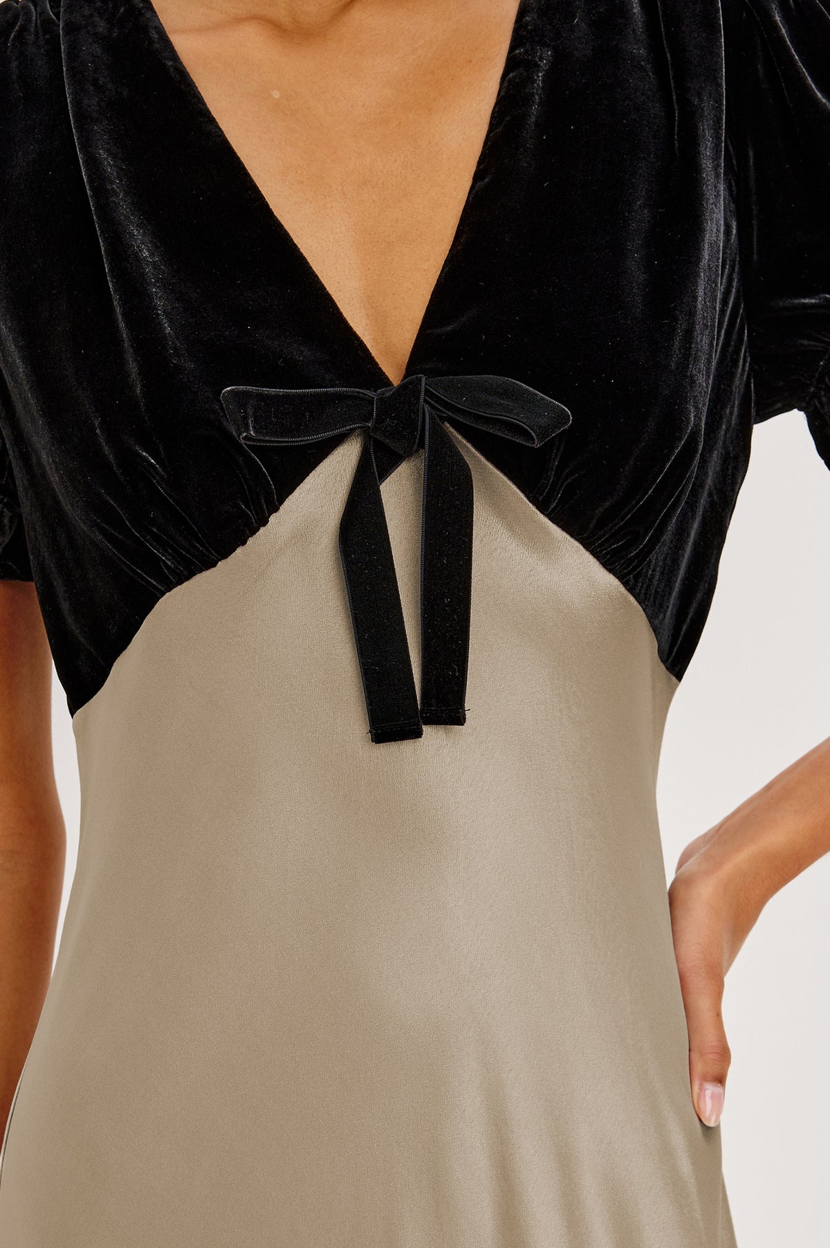 Dory Maxi Dress With V-Neckline and Adjustable Center Bust Ties, Short Puff Sleeves, Satin Back Crepe Skirt, and Back Zipper Closure in Mink Colorway - Front Detail Upper Body View Featured on Model.