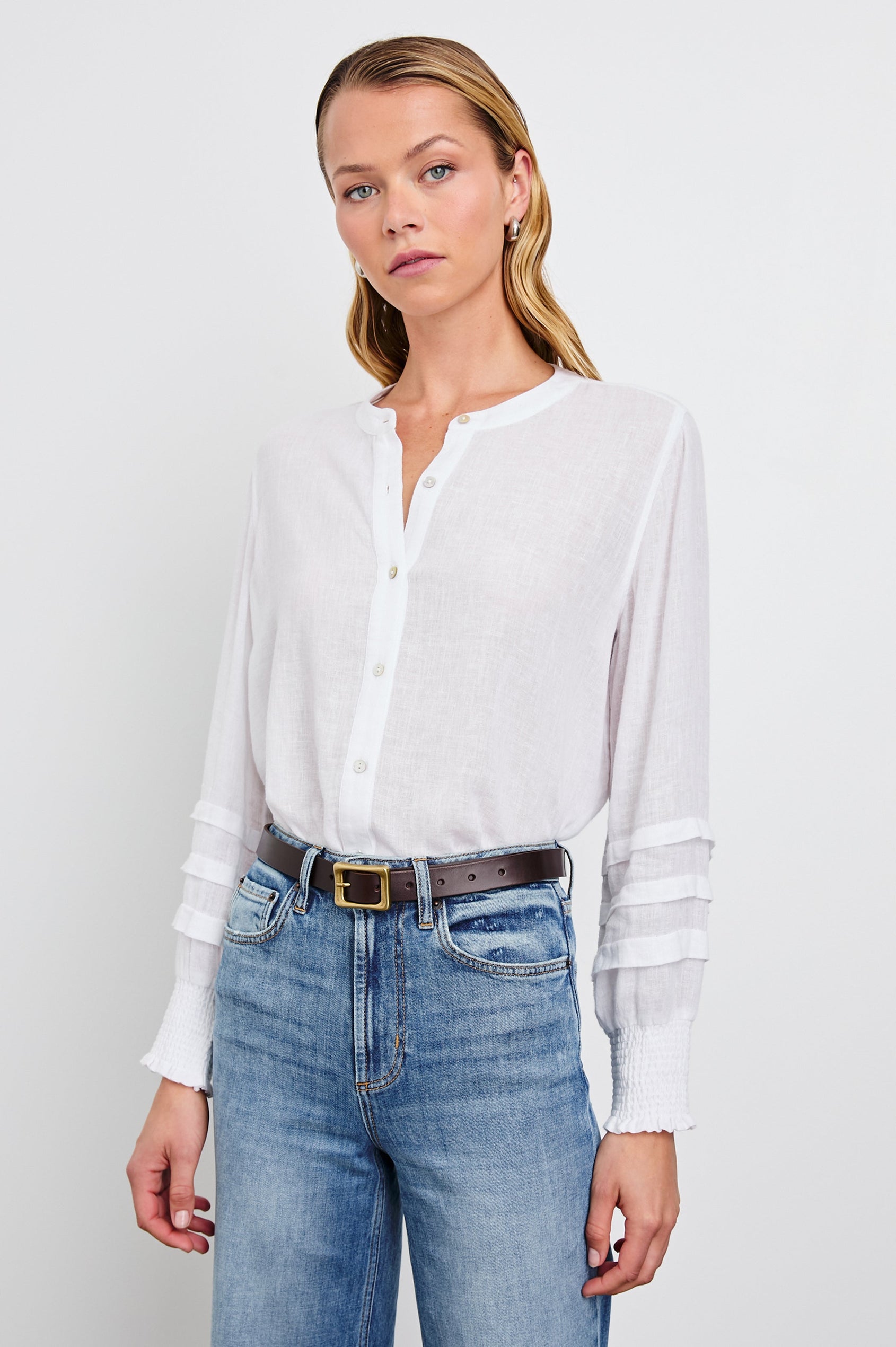 Dove Long-Sleeve Top with Buttons down the Front, Shirred Cuffs and Three Horizontal Pleats on the Lower Sleeves in White Colorway - Front Tucked View Featured on Model