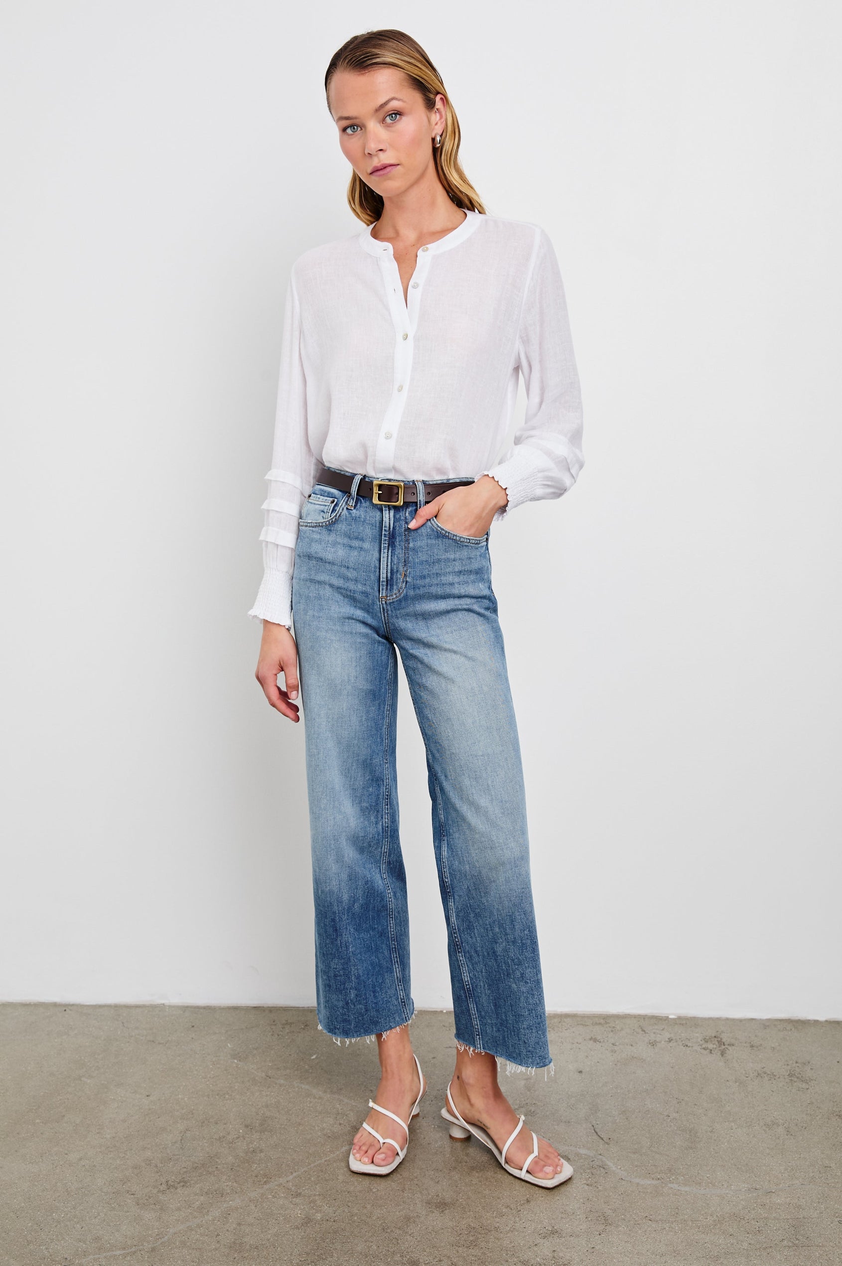 Dove Long-Sleeve Top with Buttons down the Front, Shirred Cuffs and Three Horizontal Pleats on the Lower Sleeves in White Colorway - Front Tucked Full Body View Featured on Model