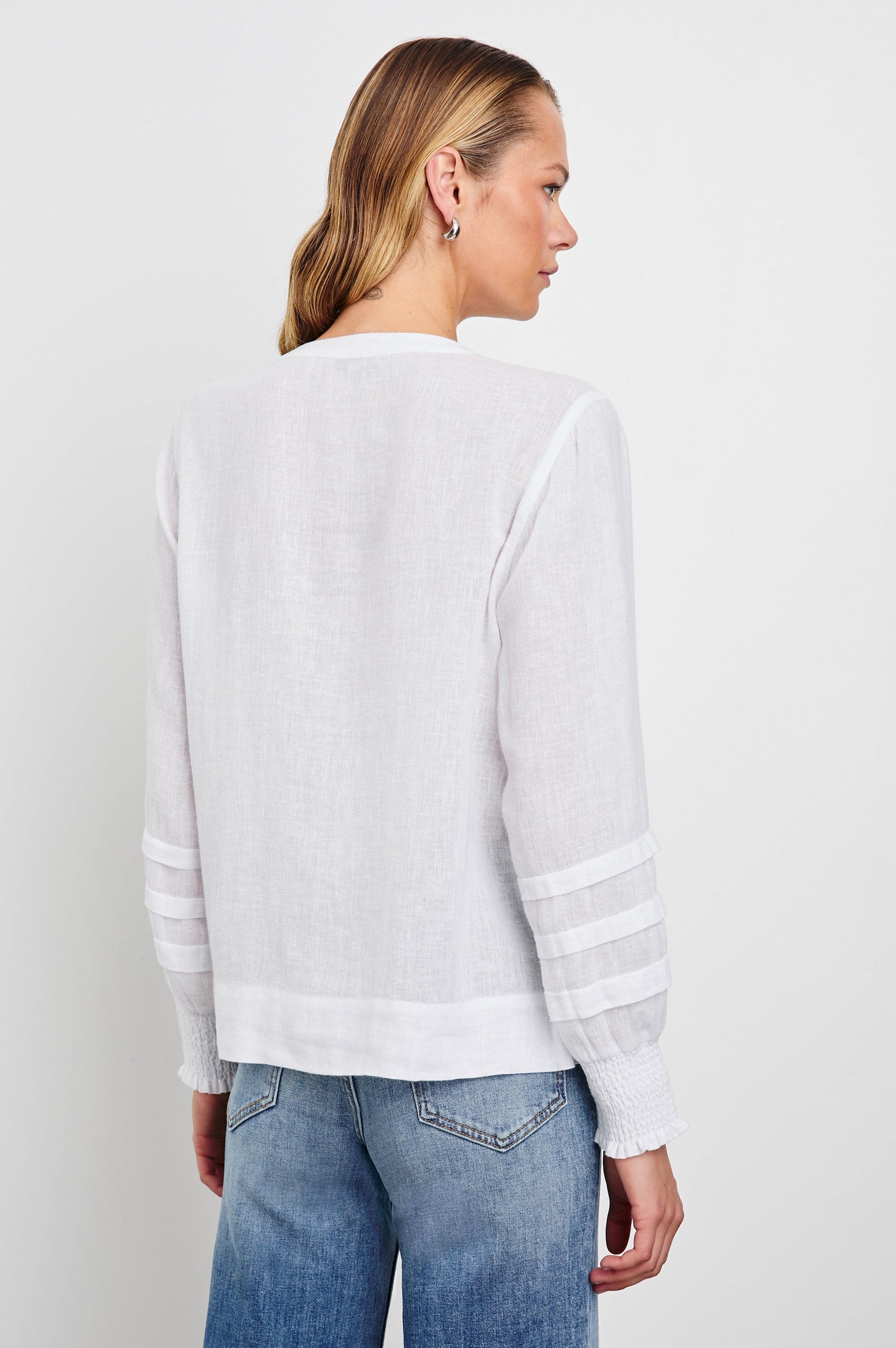 Dove Long-Sleeve Top with Buttons down the Front, Shirred Cuffs and Three Horizontal Pleats on the Lower Sleeves in White Colorway - Back View Featured on Model