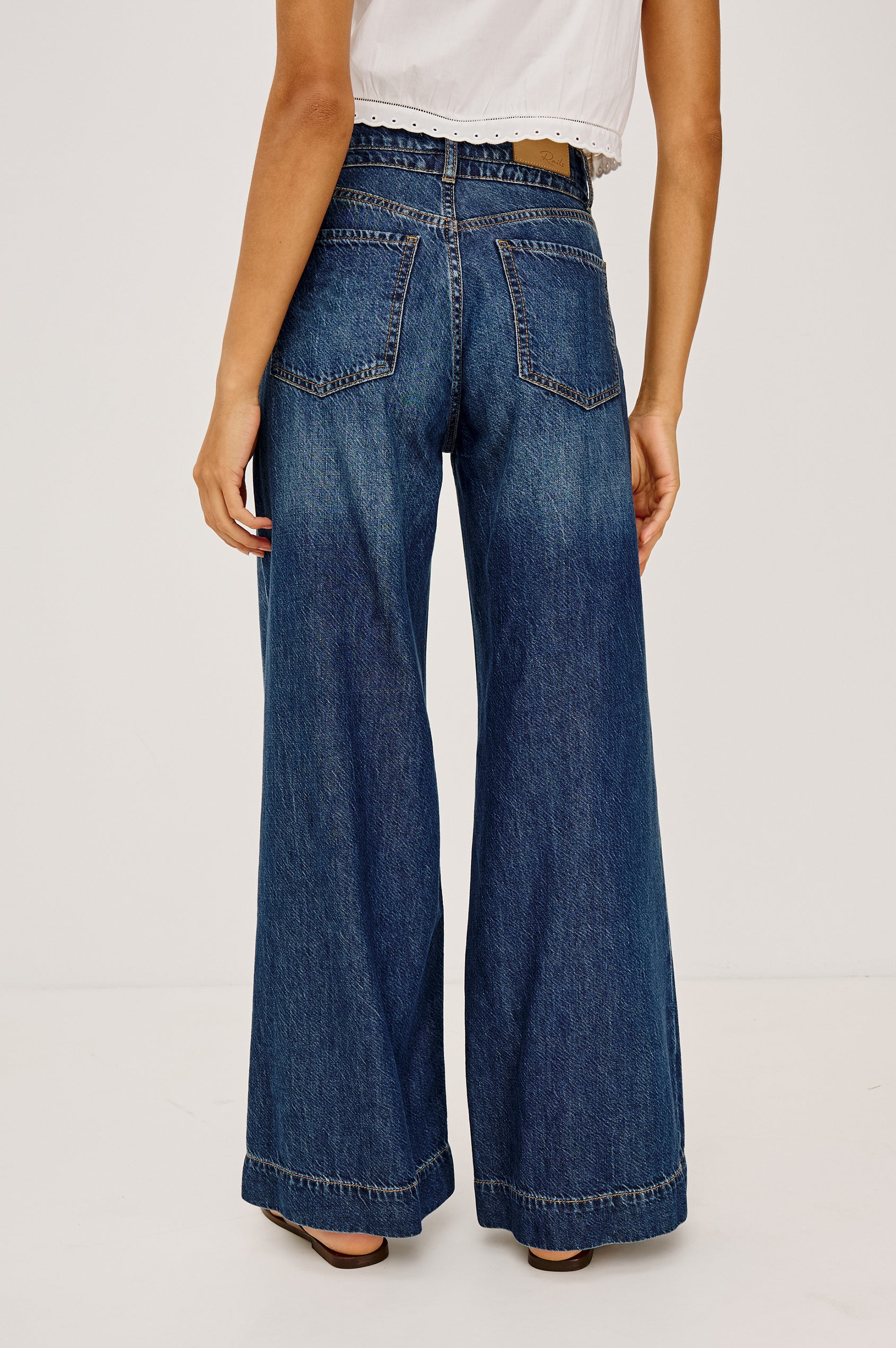 Dover High-Rise Palazzo Jean in Rigid Denim With Relaxed Fit, Zip Fly, Adjustable Waist Ties, and Wide, Drapey Legs in Boondocks Colorway - Lower Body Back View Featured on Model