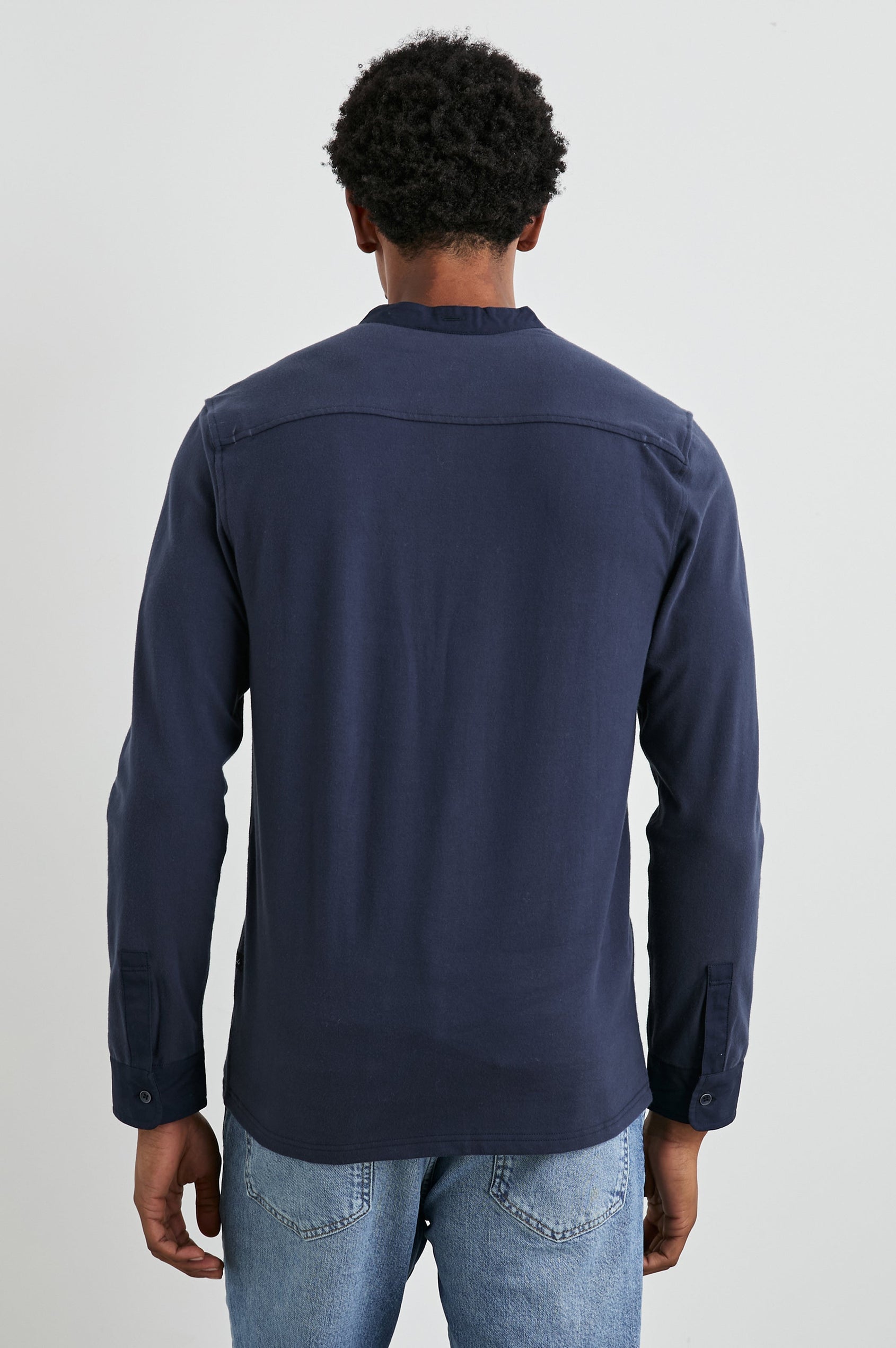 Dremond Long Sleeve Shirt with a Three Button Placket and Buttoned Cuffs in Perfect Navy Colorway - Back View Featured on Model