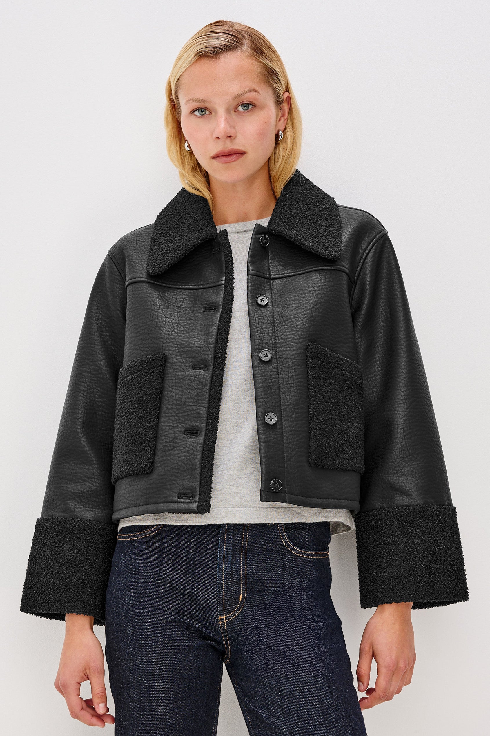 Dria Jacket with Button Closure, Two Front Patch Pockets and Faux Shearling at the Pockets, Cuffs, Collar and Opening in Black Shearling Colorway, Front View Featured on Model 