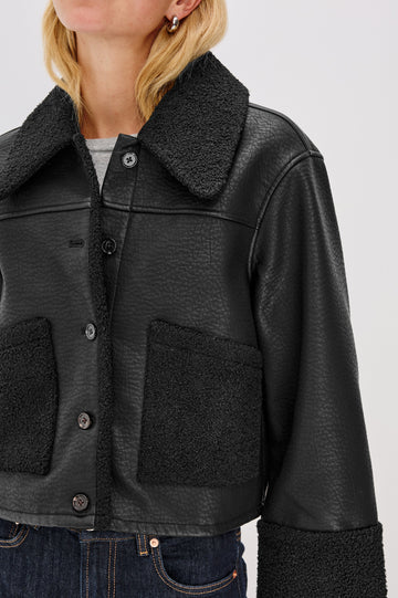 Dria Jacket with Button Closure, Two Front Patch Pockets and Faux Shearling at the Pockets, Cuffs, Collar and Opening in Black Shearling Colorway, Close Up View Featured on Model 