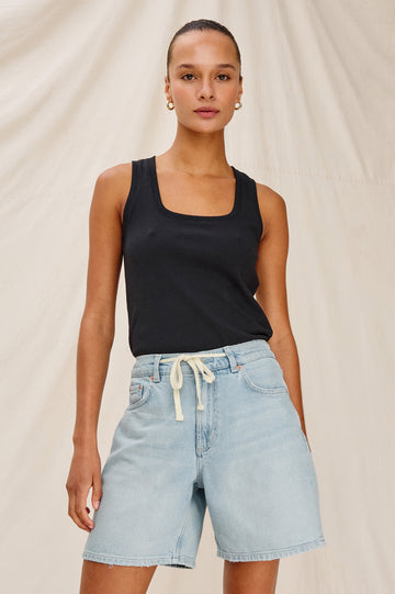 Dume Denim Short, Five Pocket, Zip Fly, Mid-Thigh Length with a White Drawstring Tie Waist in Light Wash Scuba Colorway. Front View Shown on Model.