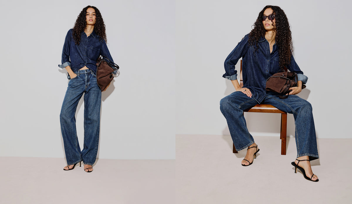 A split-screen fashion photo showing a woman modeling a dark blue denim shirt and wide-leg blue jeans in two poses against a plain light gray studio background. She is holding a brown shoulder bag and wearing black heeled sandals.