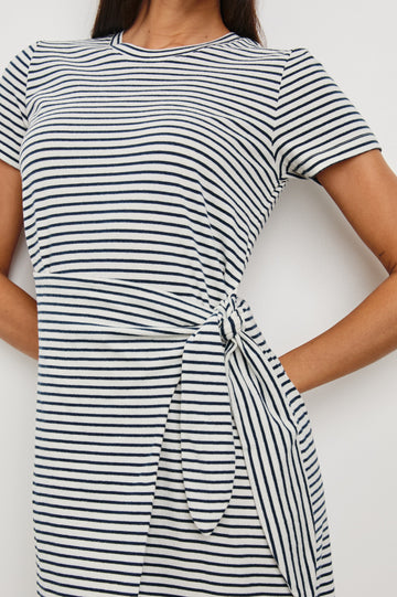 Edie Above-Knee Dress with Short Sleeves, Crew Neckline and Adjustable Wrap Tie At Waist in Ivory Navy Micro Stripe Colorway, Horizontal Stripes - Front View Featured on Model