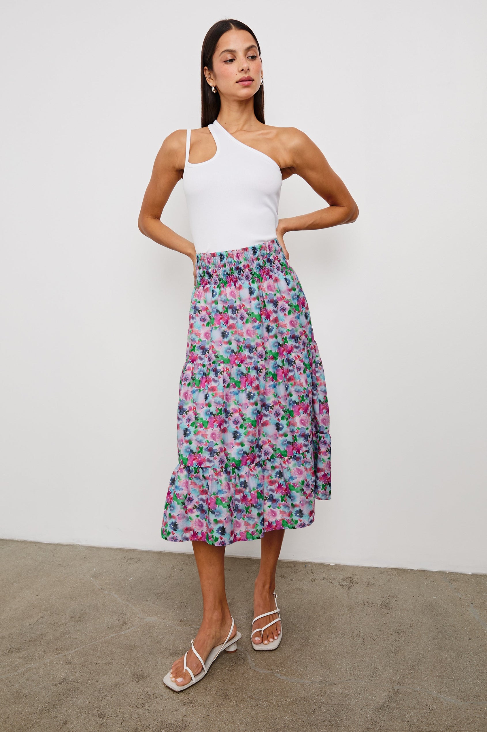 Edina Tiered Midi Skirt with Shirred High-Rise Waistline in Spring Floral Colorway, with mostly pinks and purples - Front Full Body View Featured on Model