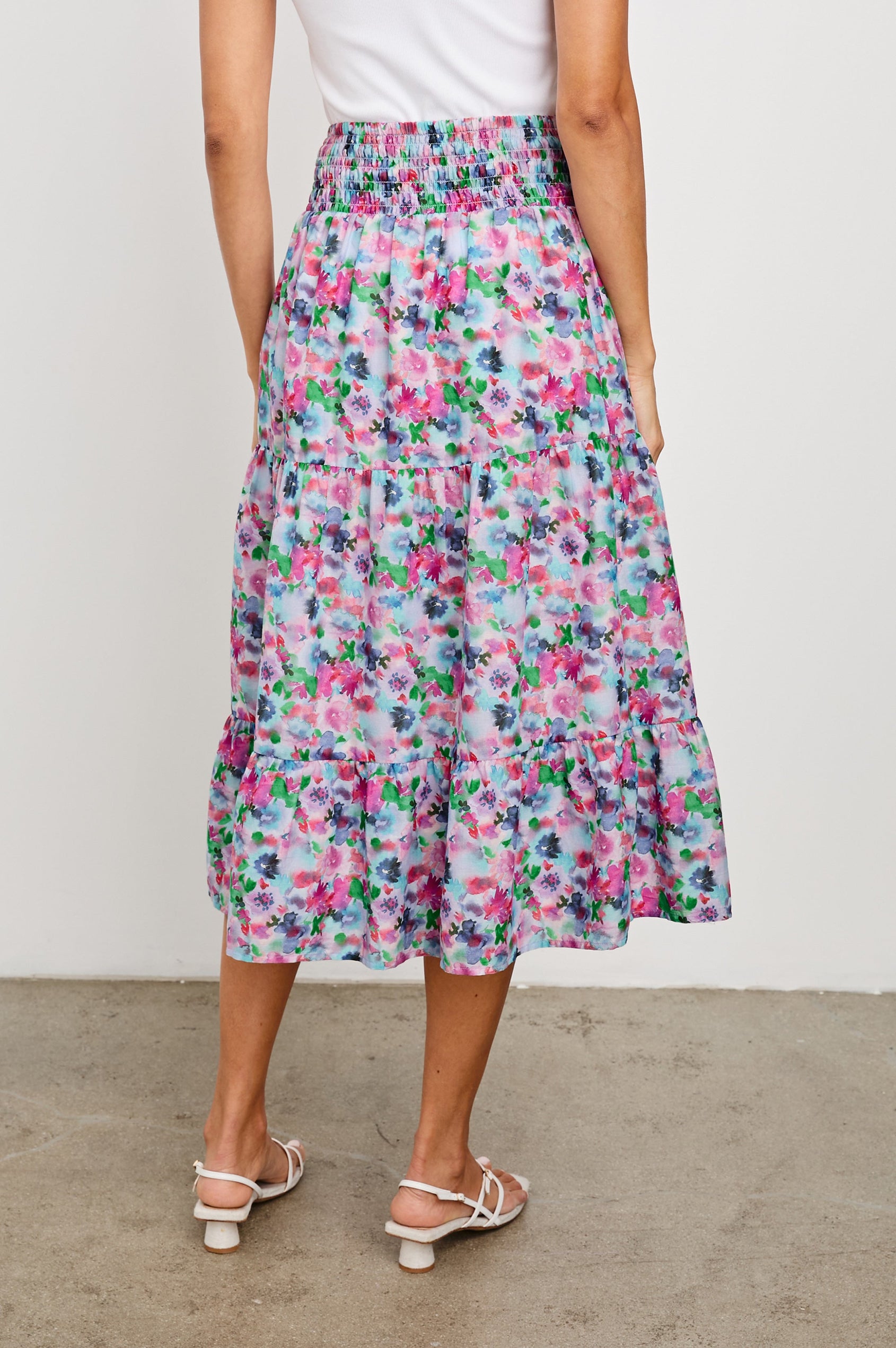 Edina Tiered Midi Skirt with Shirred High-Rise Waistline in Spring Floral Colorway, with mostly pinks and purples - Back View Featured on Model