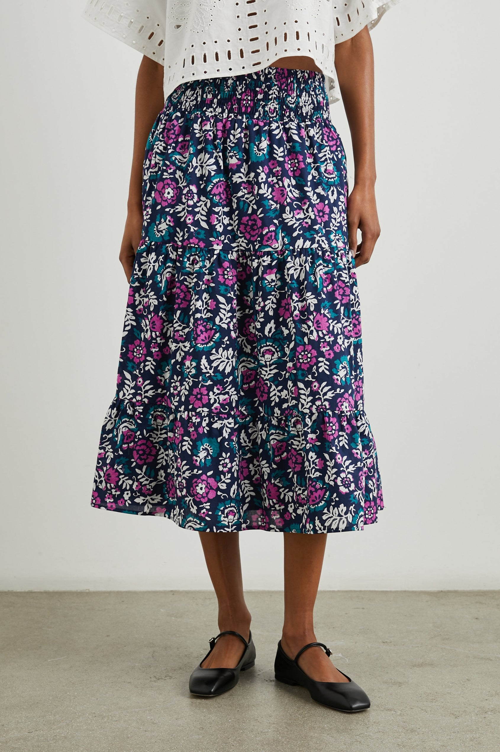 Edina Tiered Midi Skirt with Shirred High-Rise Waistline in Lilac Roses Colorway, with large flowers in purples, blues, and white - Front View Featured on Model