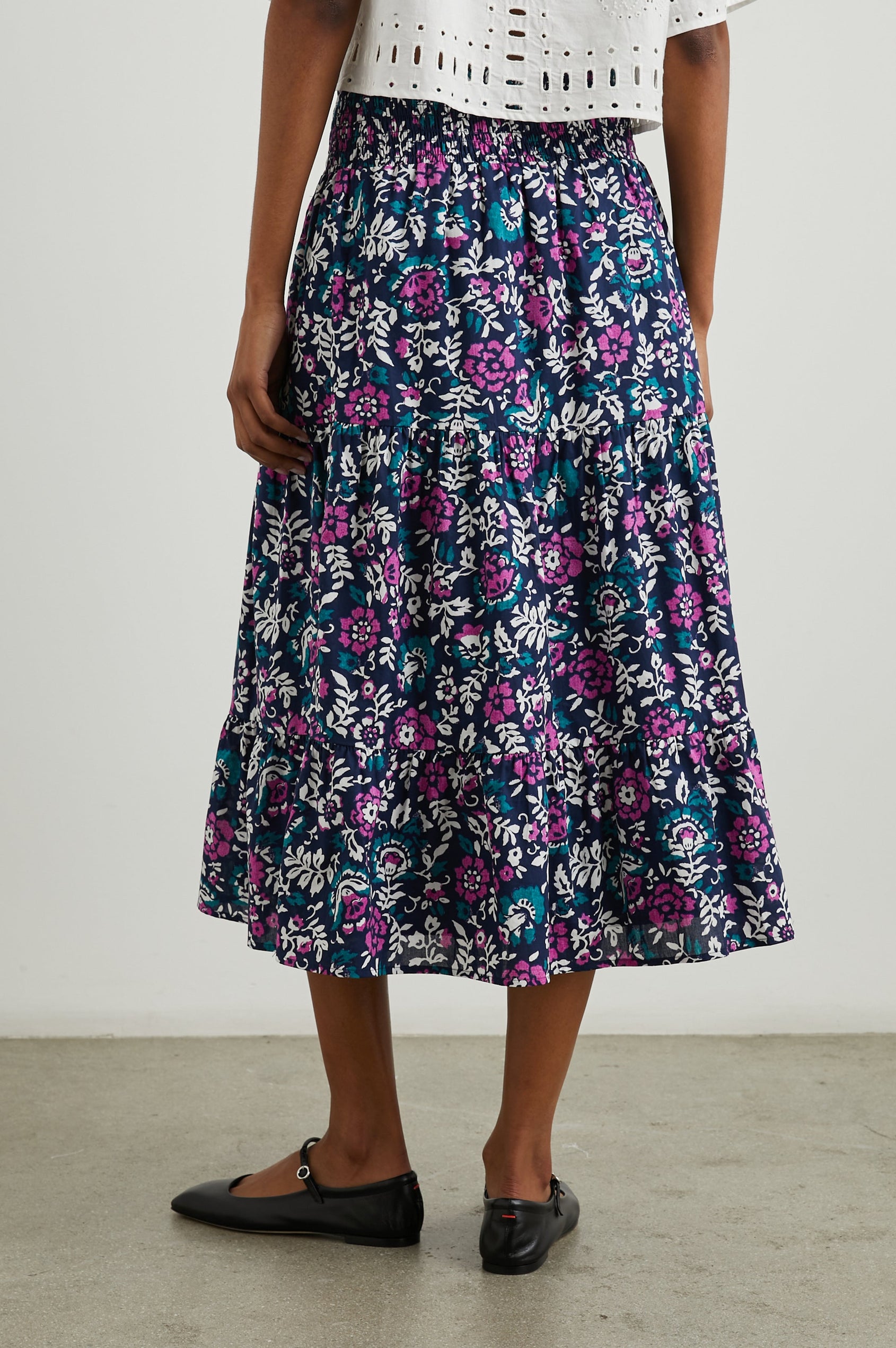 Edina Tiered Midi Skirt with Shirred High-Rise Waistline in Lilac Roses Colorway, with large flowers in purples, blues, and white - Back View Featured on Model