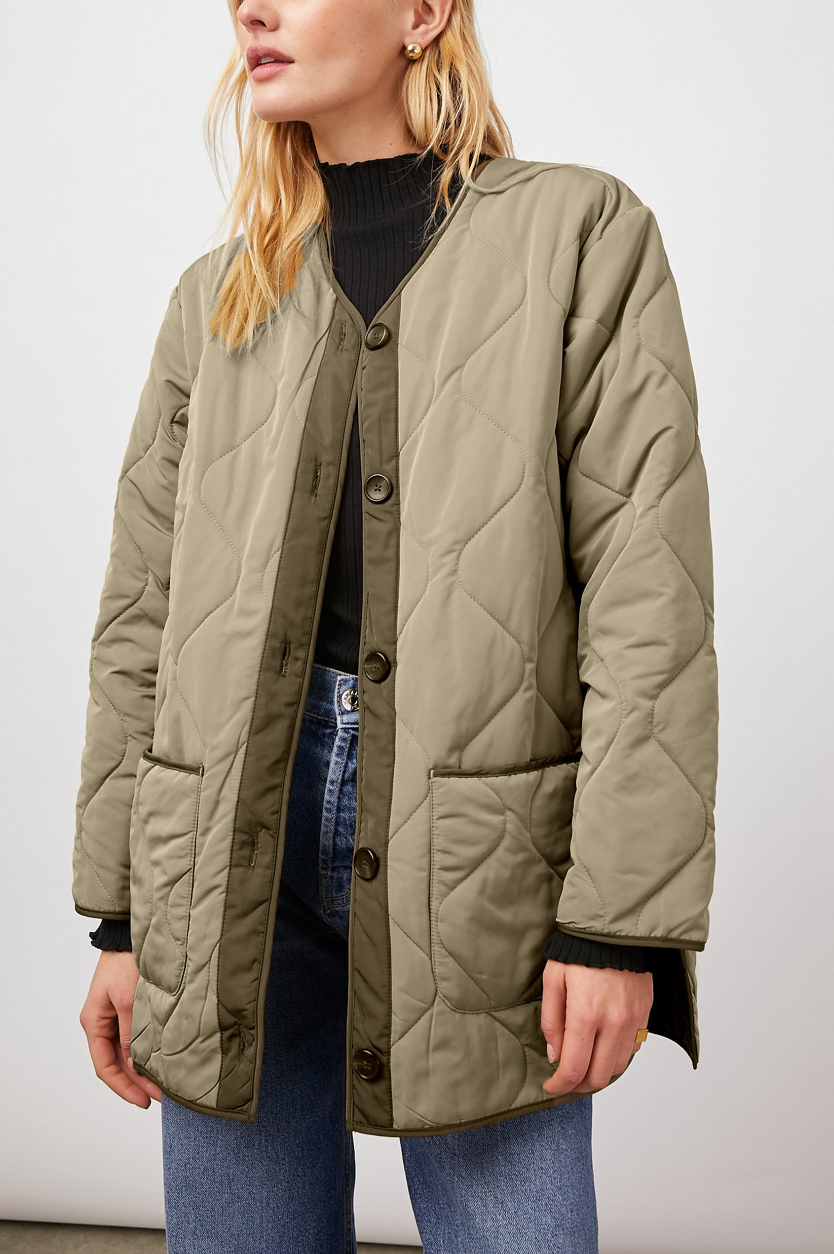 Elin Quilted Jacket with Button Closure, Side Slits, Low High Hem, Two Front Patch Pockets, and No Collar in Sage Colorway, with Darker Placket and Cuffs - Front View Featured on Model 