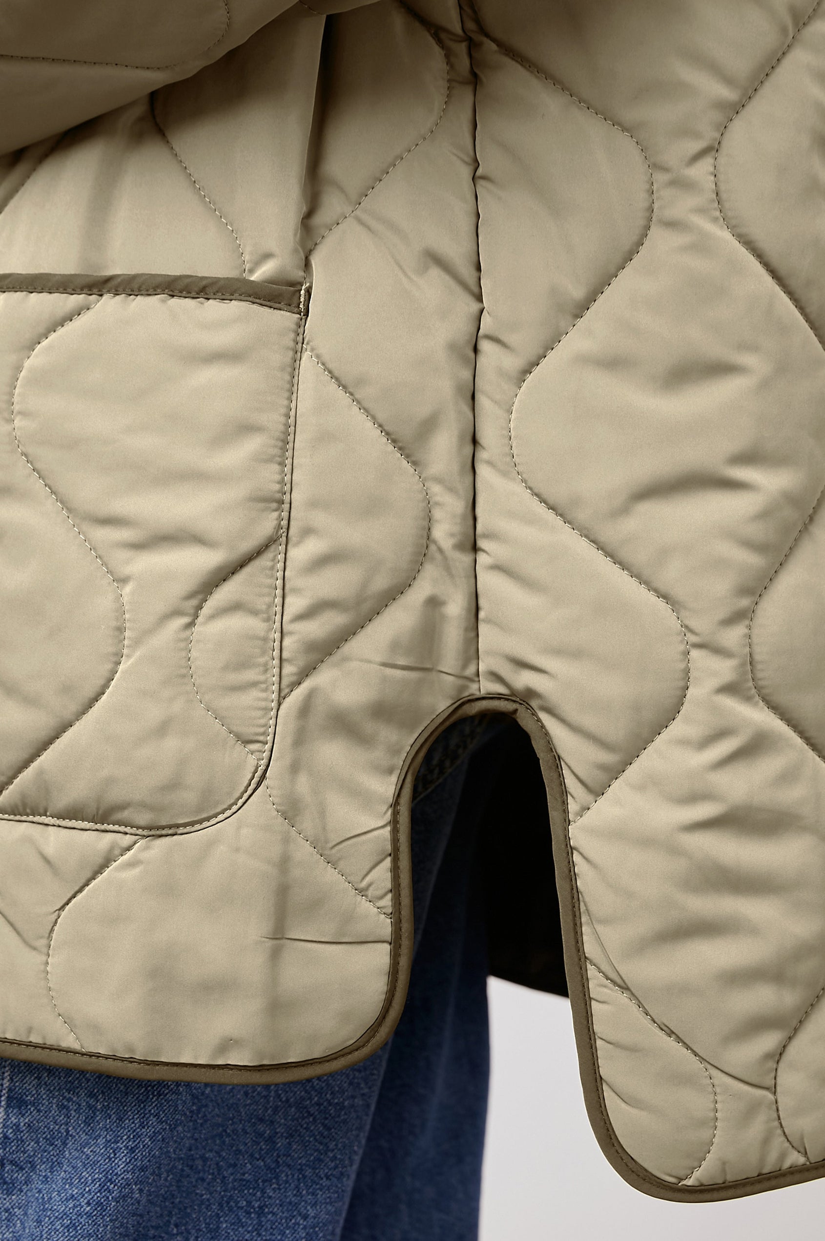 Elin Quilted Jacket with Button Closure, Side Slits, Low High Hem, Two Front Patch Pockets, and No Collar in Sage Colorway, with Darker Placket and Cuffs - Side View Featured on Model 