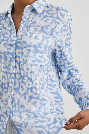 Ellis Long-Sleeve Button Down with Cuffs and a Chest Pocket in Blue Diffused Cheetah Colorway, with a diffused cheetah spot pattern - Front Untucked View Featured on Model