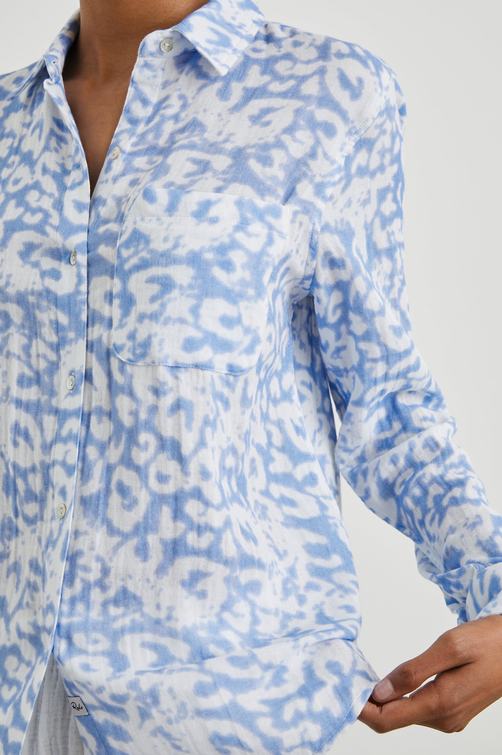 Ellis Long-Sleeve Button Down with Cuffs and a Chest Pocket in Blue Diffused Cheetah Colorway, with a diffused cheetah spot pattern - Front Untucked View Featured on Model