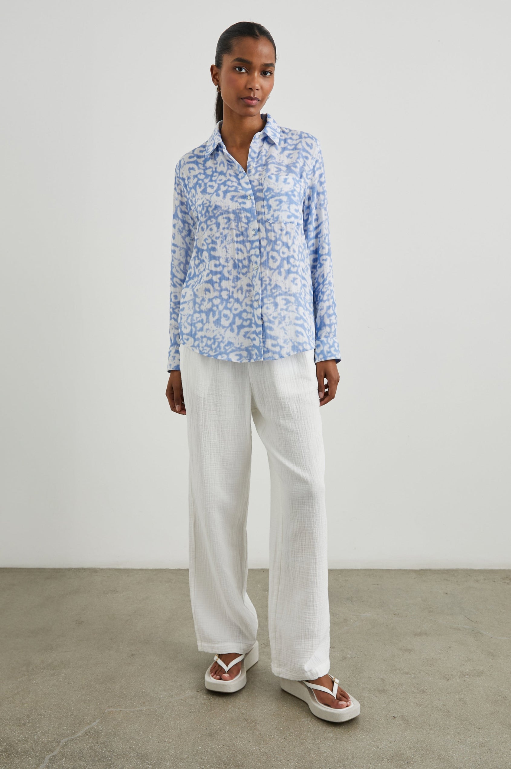 Ellis Long-Sleeve Button Down with Cuffs and a Chest Pocket in Blue Diffused Cheetah Colorway, with a diffused cheetah spot pattern - Front Untucked Full Body View Featured on Model