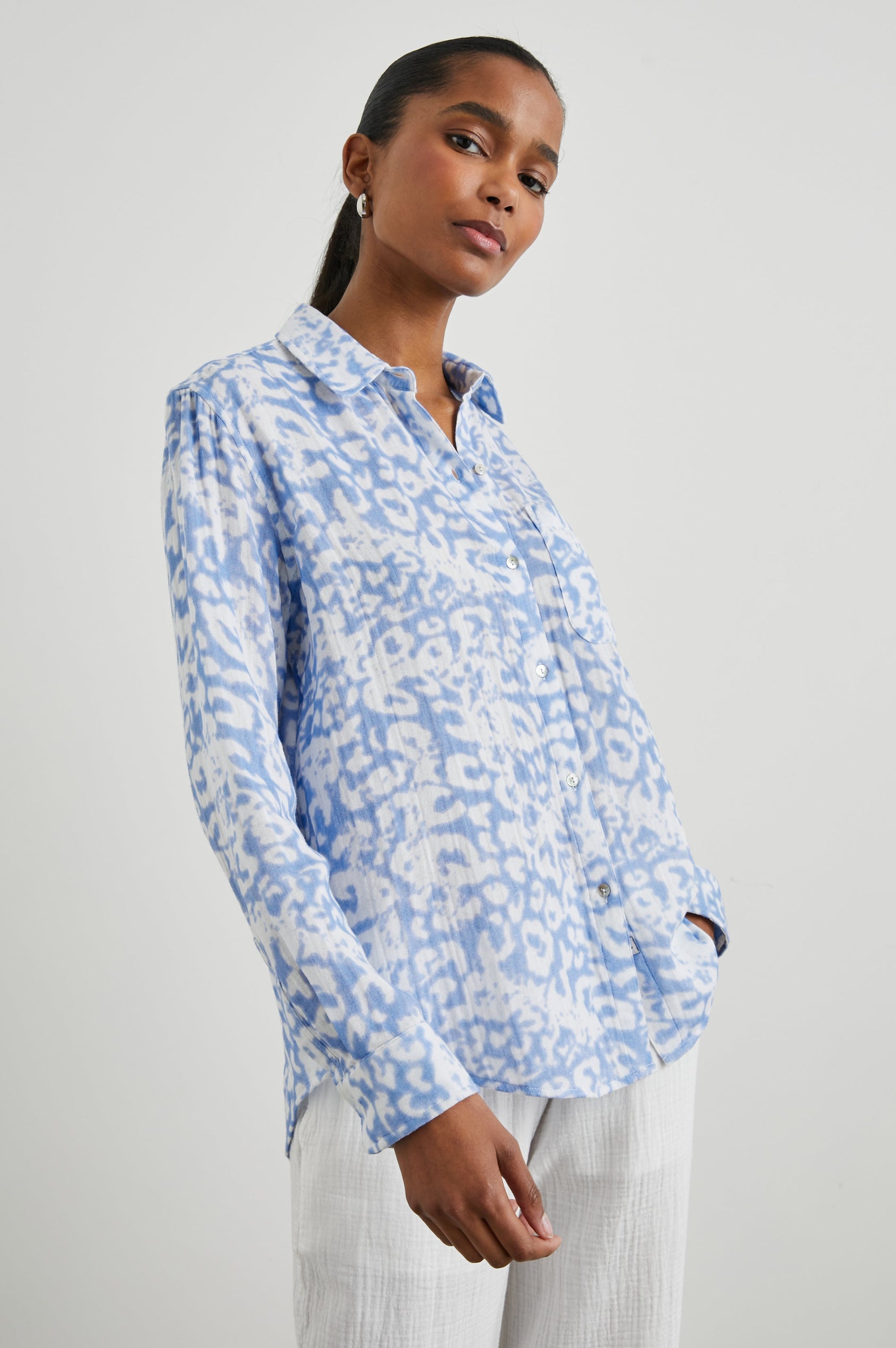 Ellis Long-Sleeve Button Down with Cuffs and a Chest Pocket in Blue Diffused Cheetah Colorway, with a diffused cheetah spot pattern - Front Untucked View Featured on Model