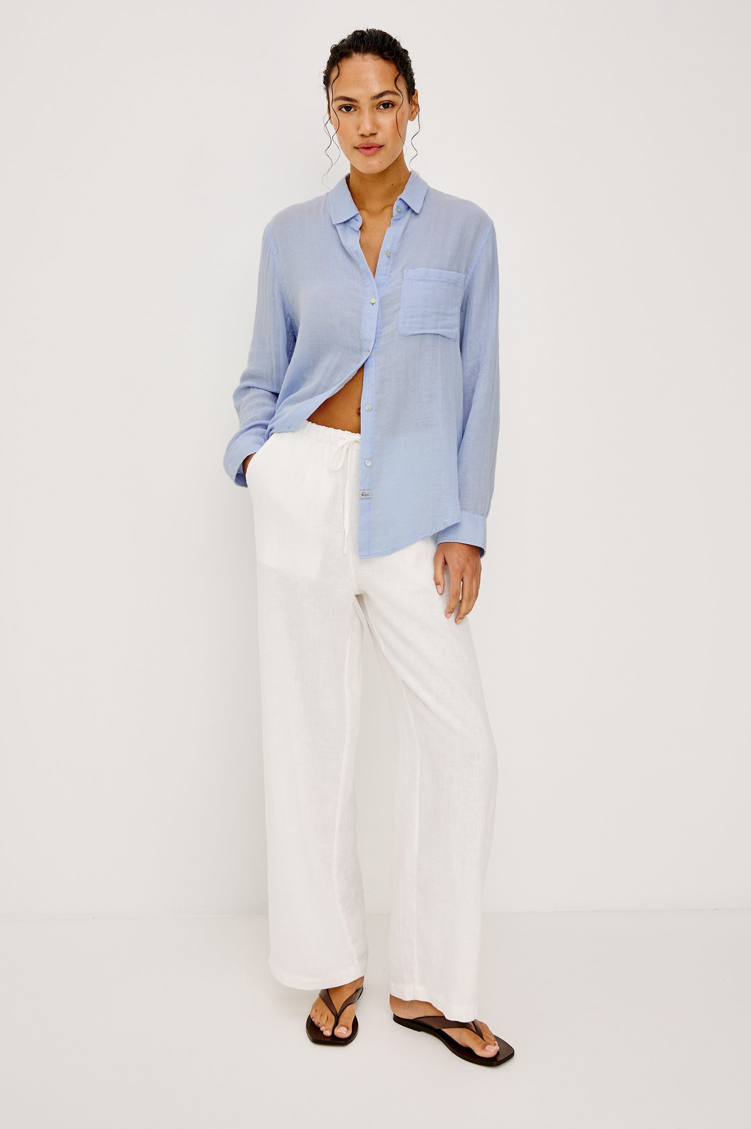 Ellis Relaxed Collared Button Front Shirt with Long Sleeves and a Chest Pocket in Baby Blue Colorway. Full Body Front View Shown on Model.