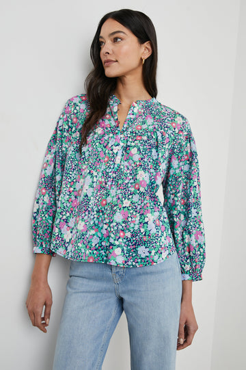 Ellison Top with Three-Quarter Sleeves, a Seven-Button Placket, and Button Cuffs in Navy Leilani Floral Colorway, Purples, Pinks and Greens on Navy - Front View Featured on Model 