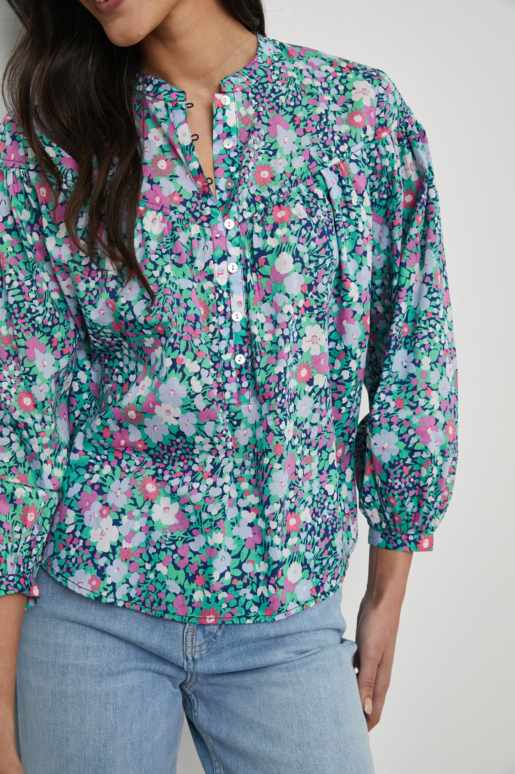 Ellison Top with Three-Quarter Sleeves, a Seven-Button Placket, and Button Cuffs in Navy Leilani Floral Colorway, Purples, Pinks and Greens on Navy - Front View Featured on Model 