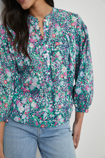 Ellison Top with Three-Quarter Sleeves, a Seven-Button Placket, and Button Cuffs in Navy Leilani Floral Colorway, Purples, Pinks and Greens on Navy - Front View Featured on Model 