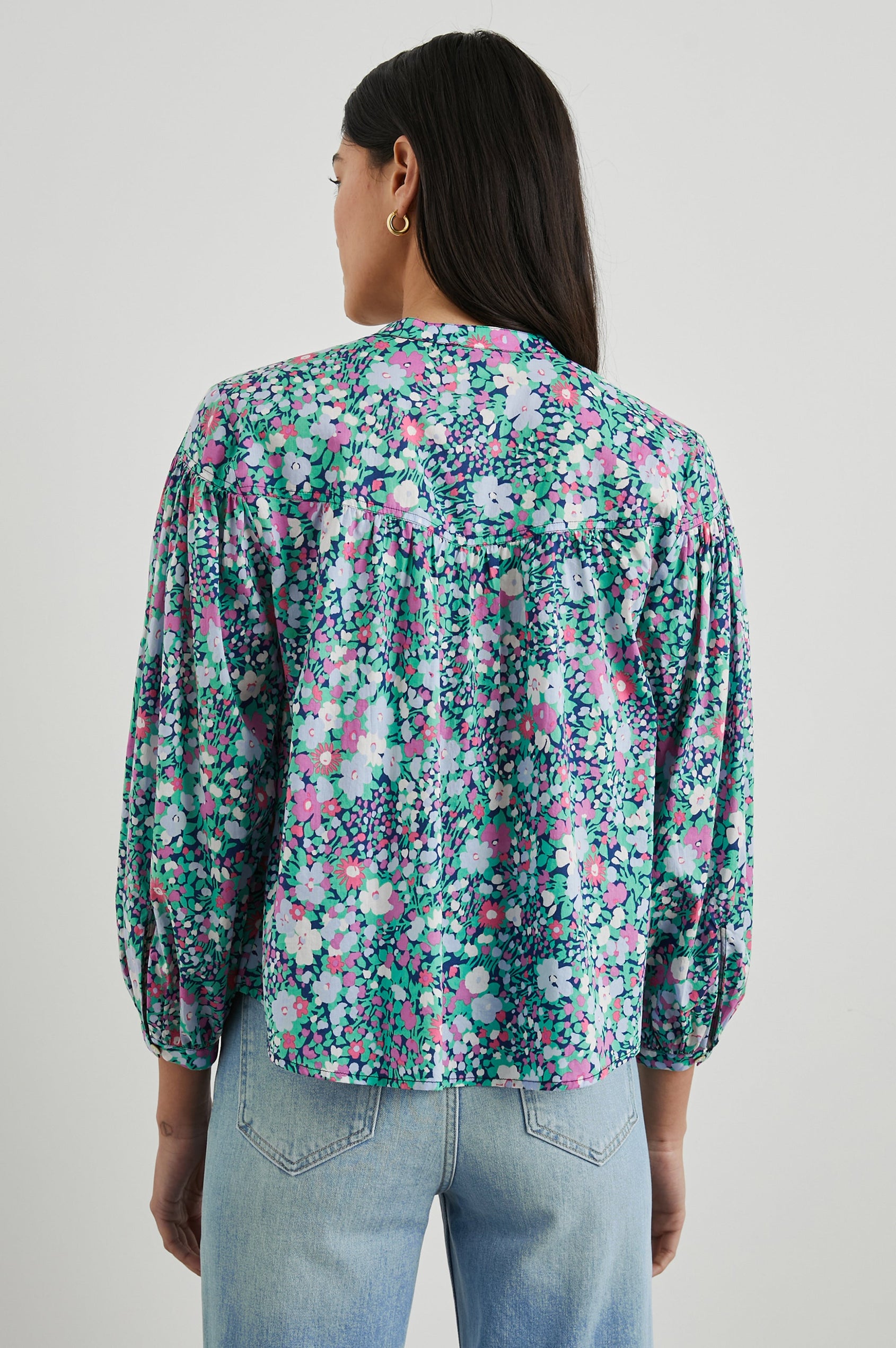 Ellison Top with Three-Quarter Sleeves, a Seven-Button Placket, and Button Cuffs in Navy Leilani Floral Colorway, Purples, Pinks and Greens on Navy - Back View Featured on Model 