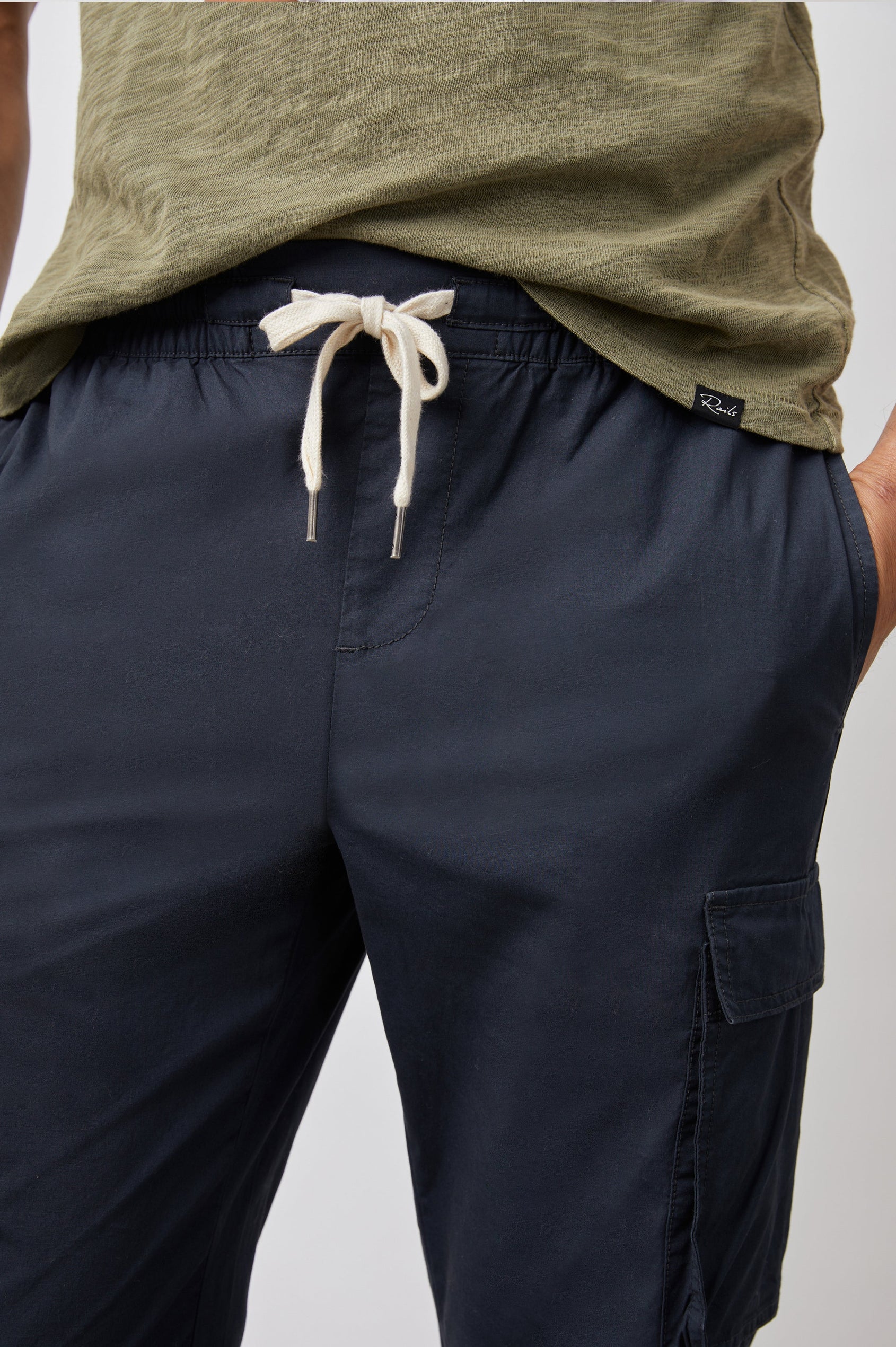 Emmerson Pants with a Drawstring Waist, Two Front Pockets, Two Side Flap Pockets and Two Back Welt Pockets in Washed Black Colorway - Front View Featured on Model