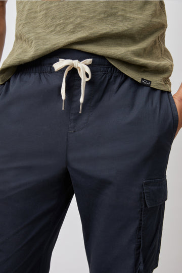 Emmerson Pants with a Drawstring Waist, Two Front Pockets, Two Side Flap Pockets and Two Back Welt Pockets in Washed Black Colorway - Front View Featured on Model