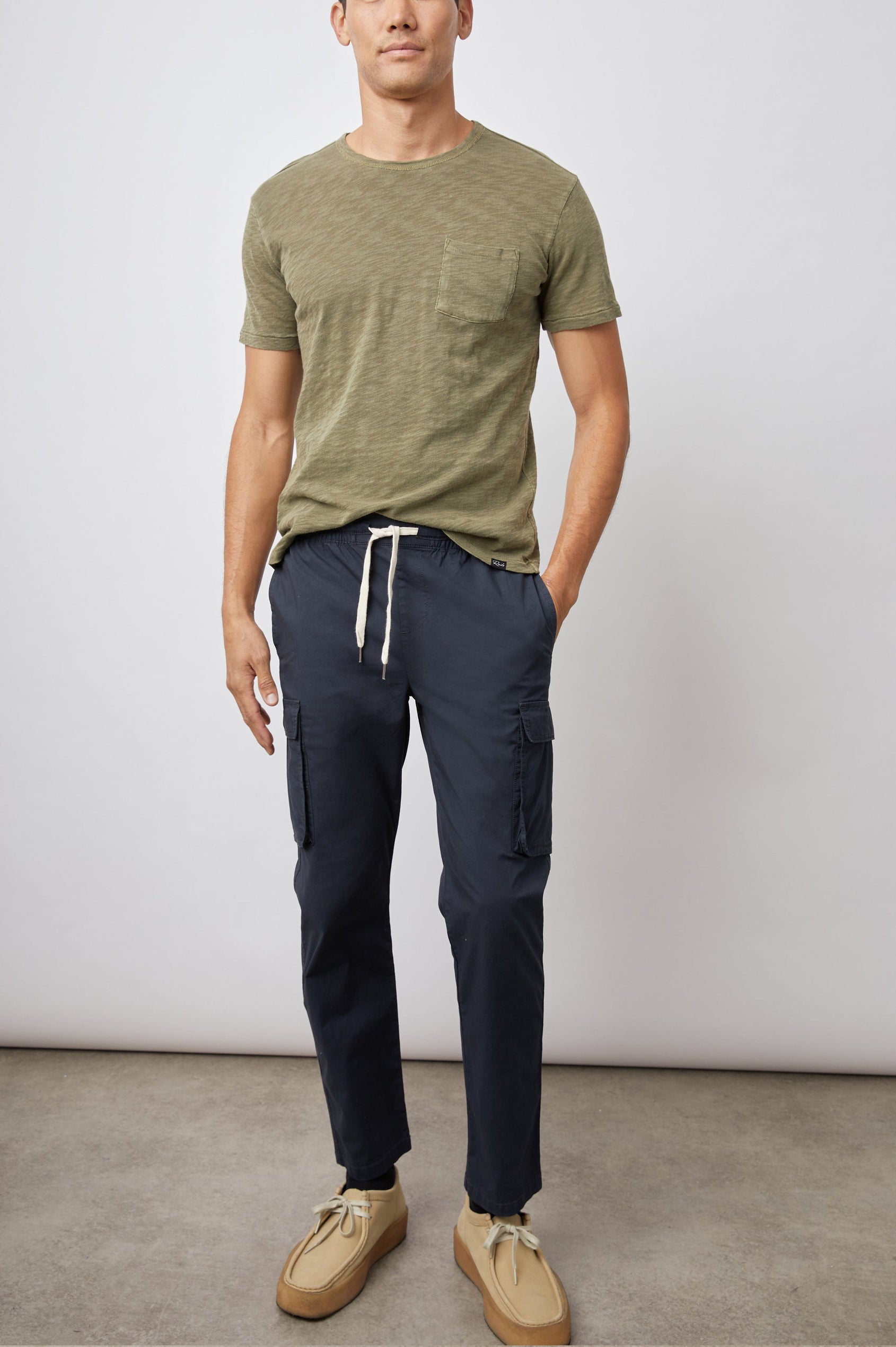 Emmerson Pants with a Drawstring Waist, Two Front Pockets, Two Side Flap Pockets and Two Back Welt Pockets in Washed Black Colorway - Front Full Body View Featured on Model