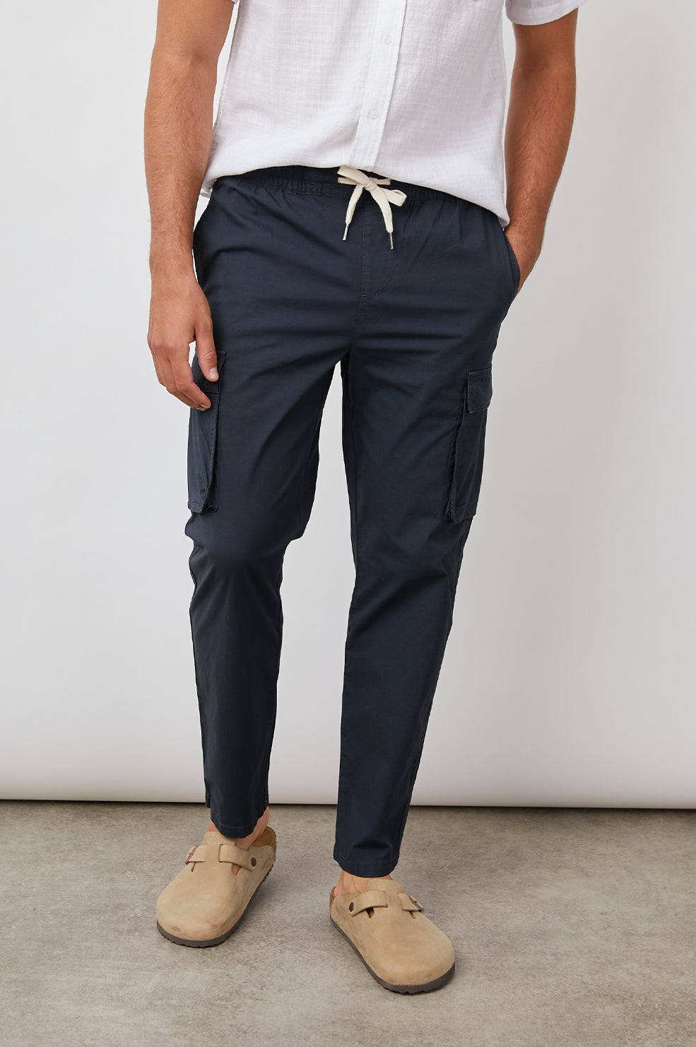 Emmerson Pants with a Drawstring Waist, Two Front Pockets, Two Side Flap Pockets and Two Back Welt Pockets in Washed Black Colorway - Front View Featured on Model