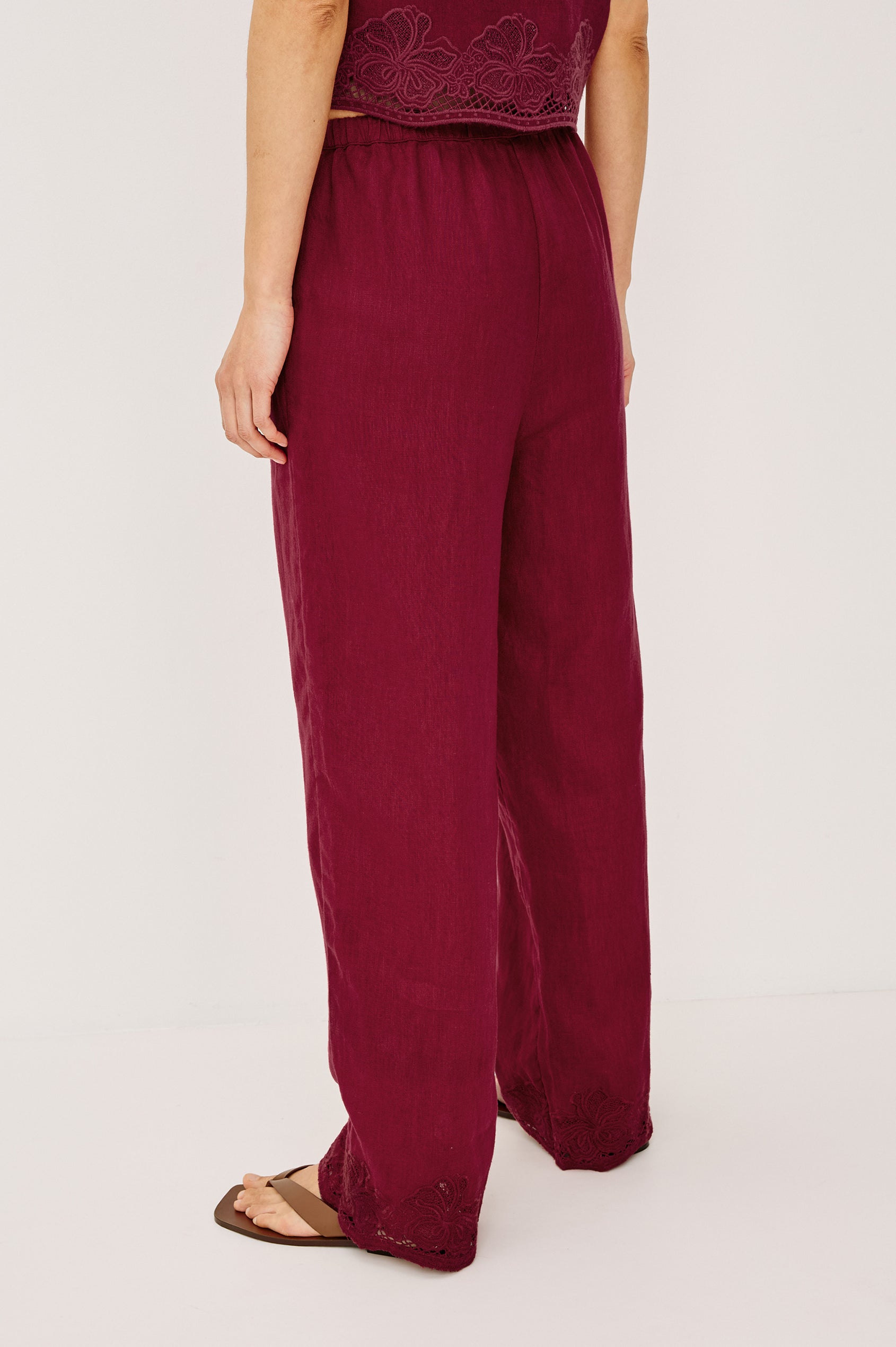 Emmie Straight Leg Pant in Linen With Adjustable Drawstring Waist Ties in Hibiscus Embroidery Colorway — Lower Body Back View Featured on Model