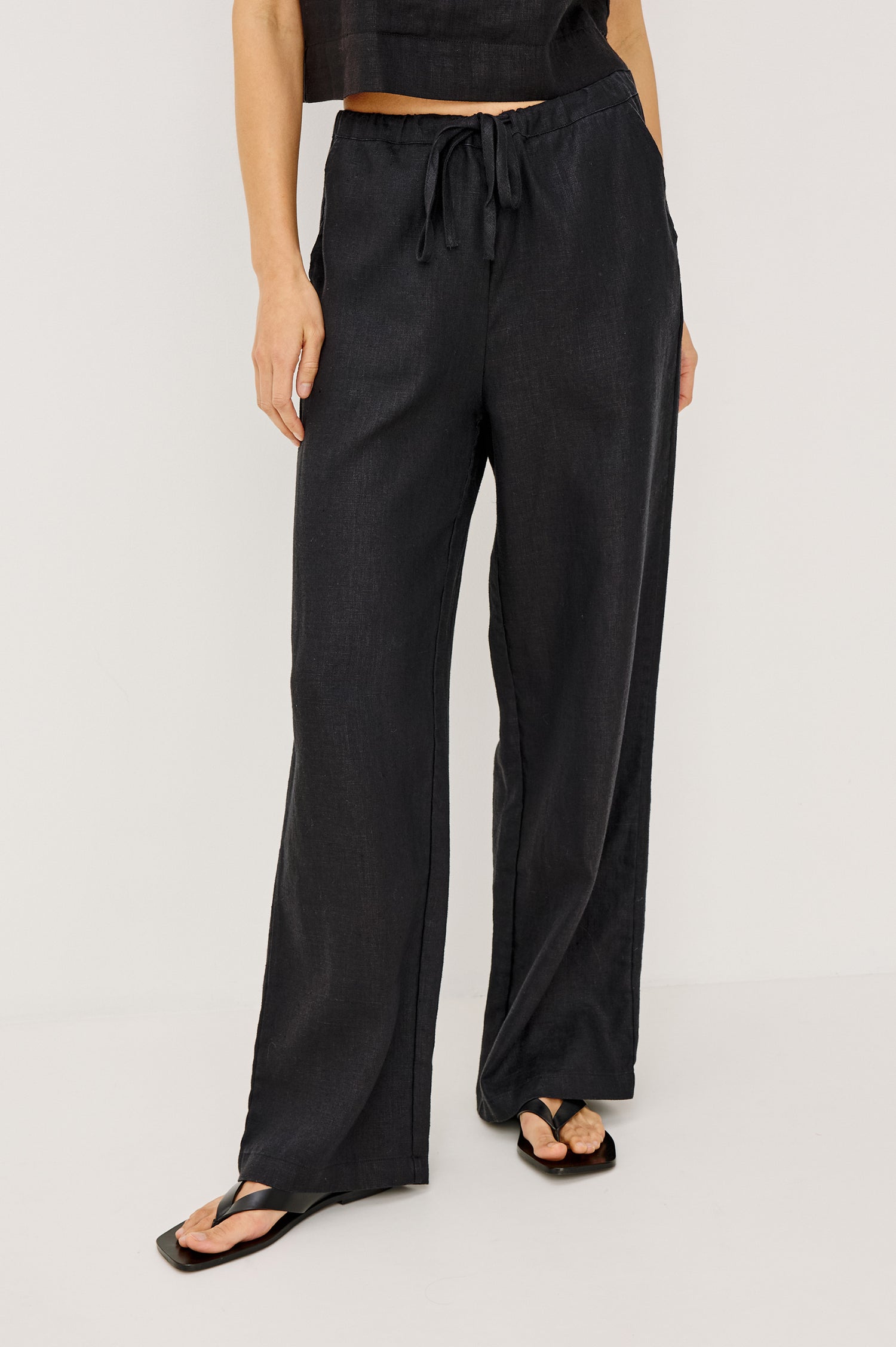 Emmie high rise linen wide leg pant with drawstring in black - front view on model