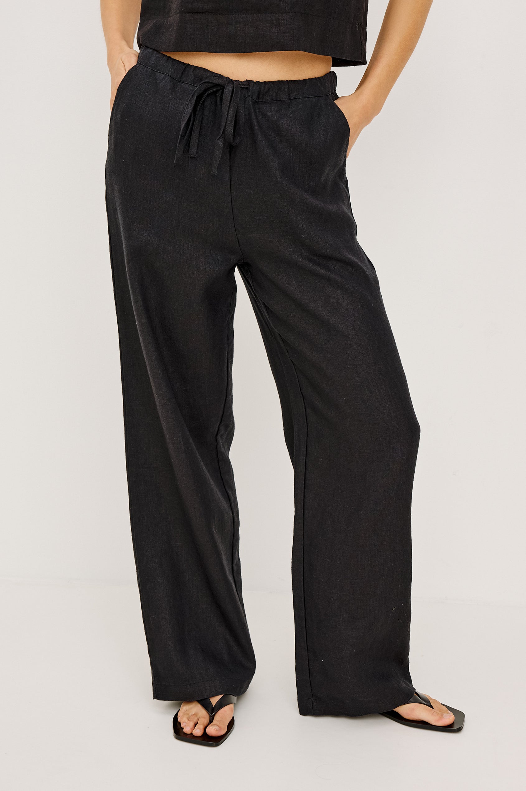 Emmie high rise linen wide leg pant with drawstring in black - front view on model