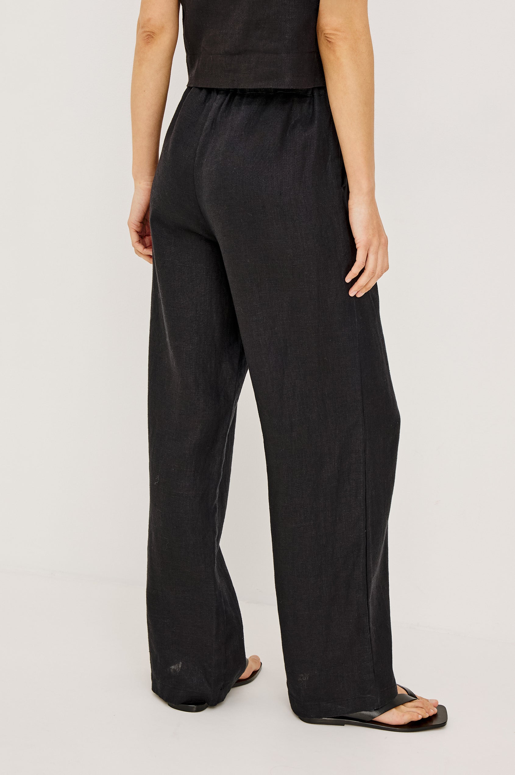 Emmie high rise linen wide leg pant with drawstring in black - front view on model