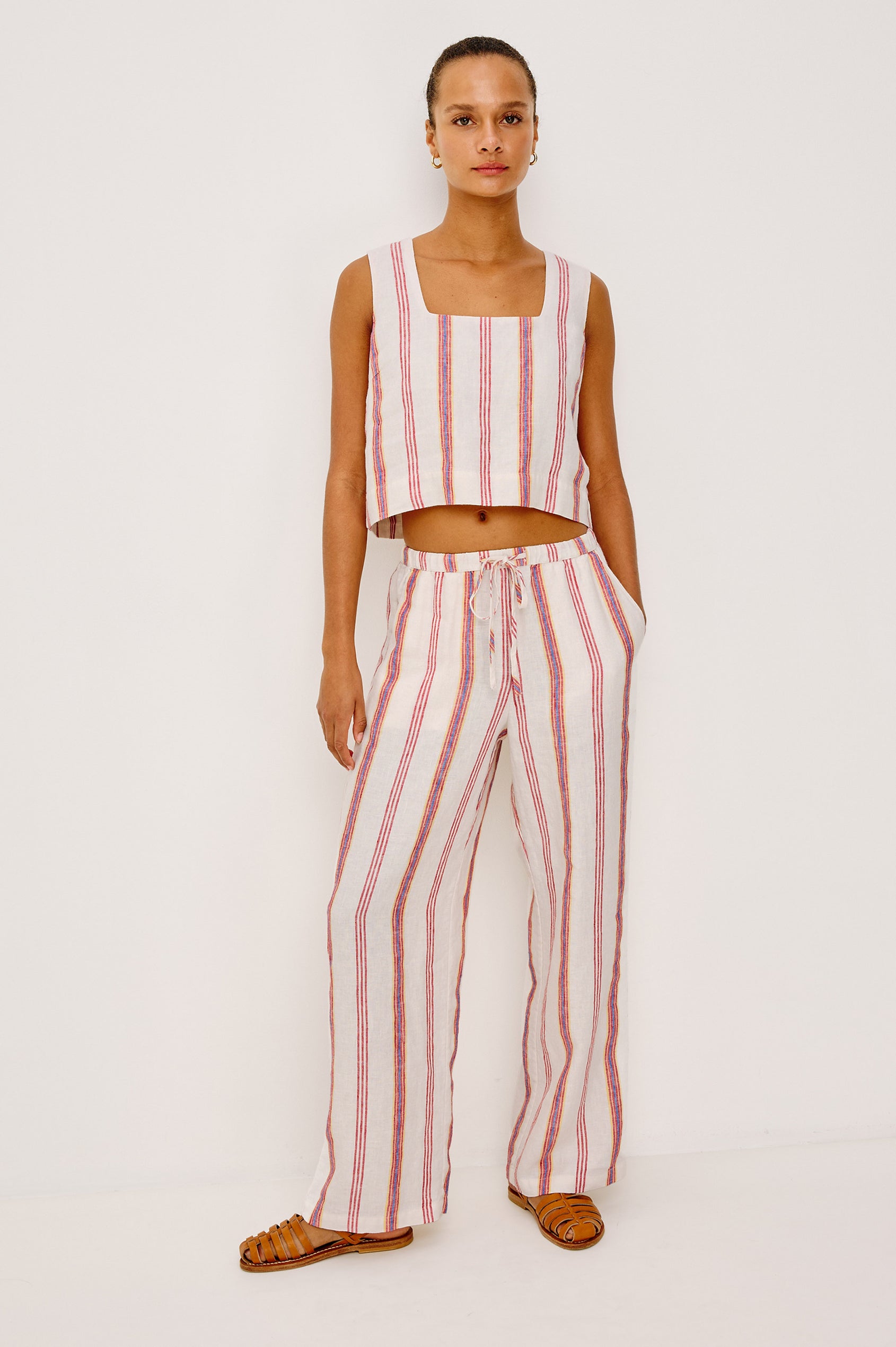 Emmie Straight Leg Pant in Unlined Linen With Adjustable Drawstring Waist Ties and Side Pockets in Primavera Stripe Colorway — Full Body Front View Featured on Model