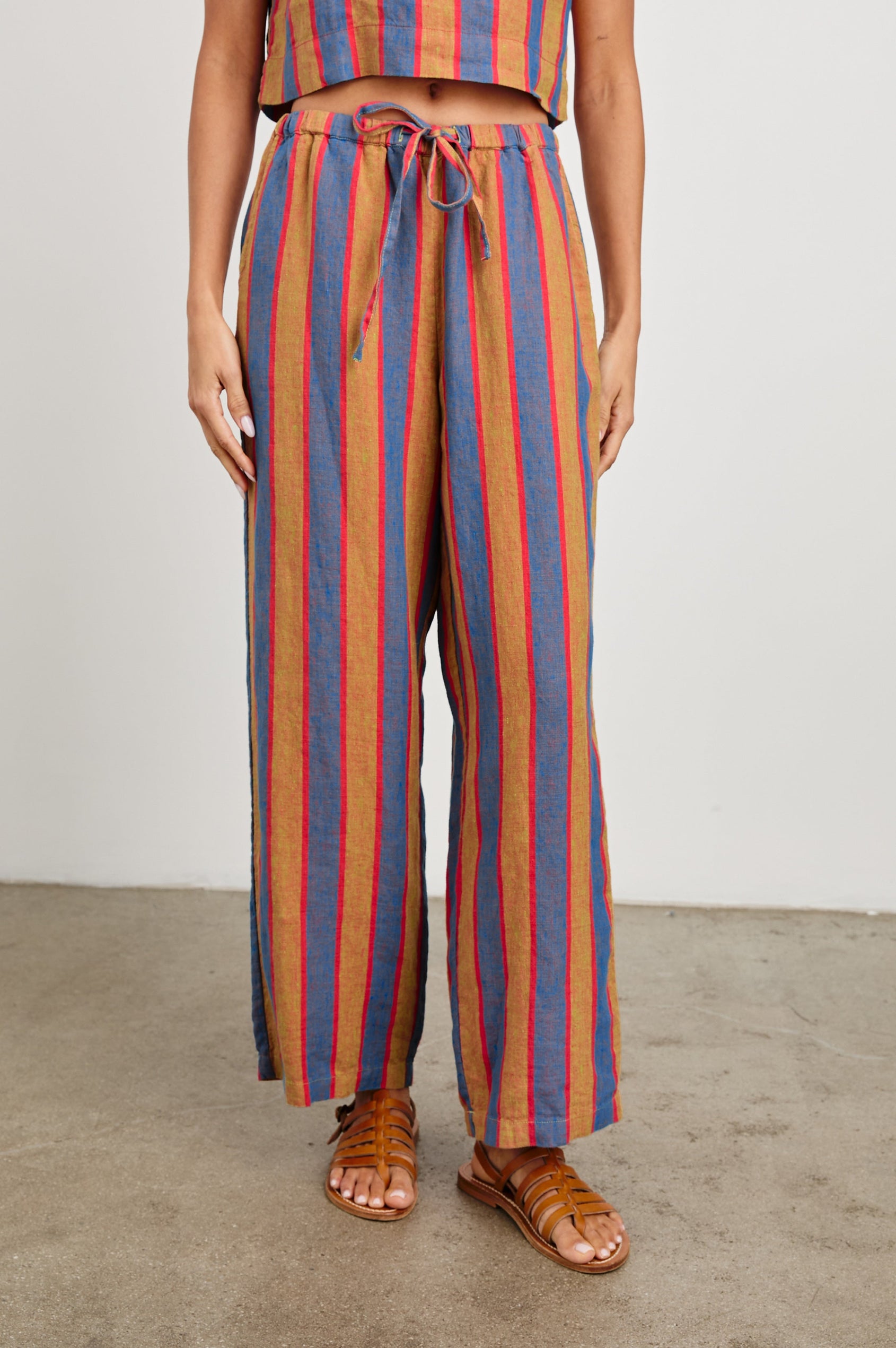 Emmie Pants with a Drawstring Waist and Two Front Pockets in Rio Stripe Colorway, Blue Tan and Pink Vertical Stripes - Front View Featured on Model