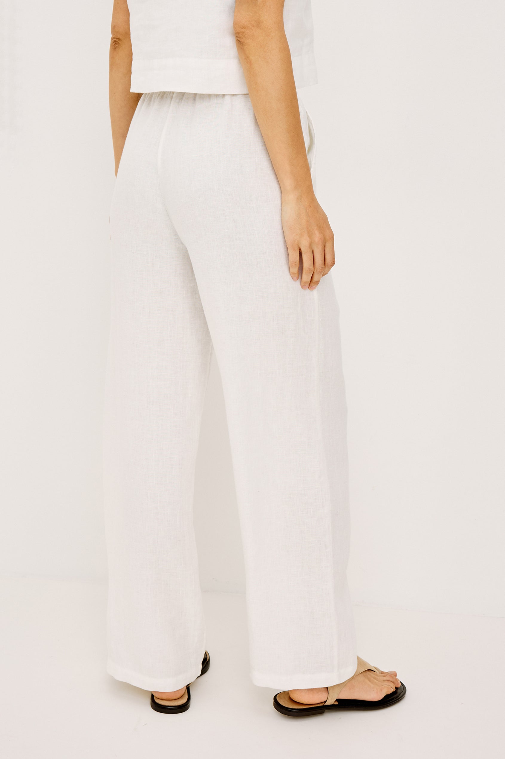 Emmie high rise linen wide leg pant with drawstring in white - front view on model