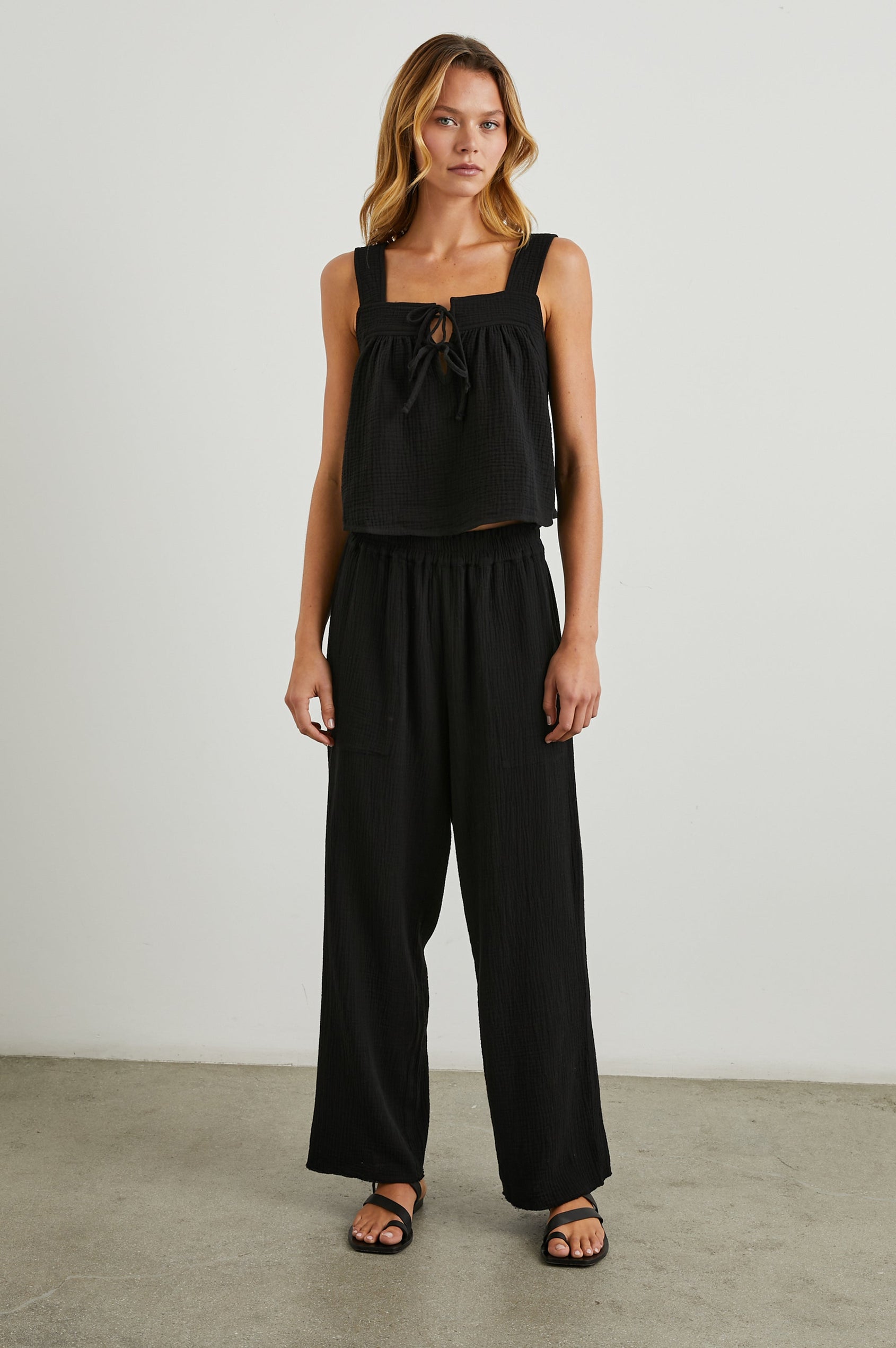 Enya Cropped Tank Top with a Square Neck with a V Cutout with Ties in Black Gauze Colorway - Front Full Body View Featured on Model