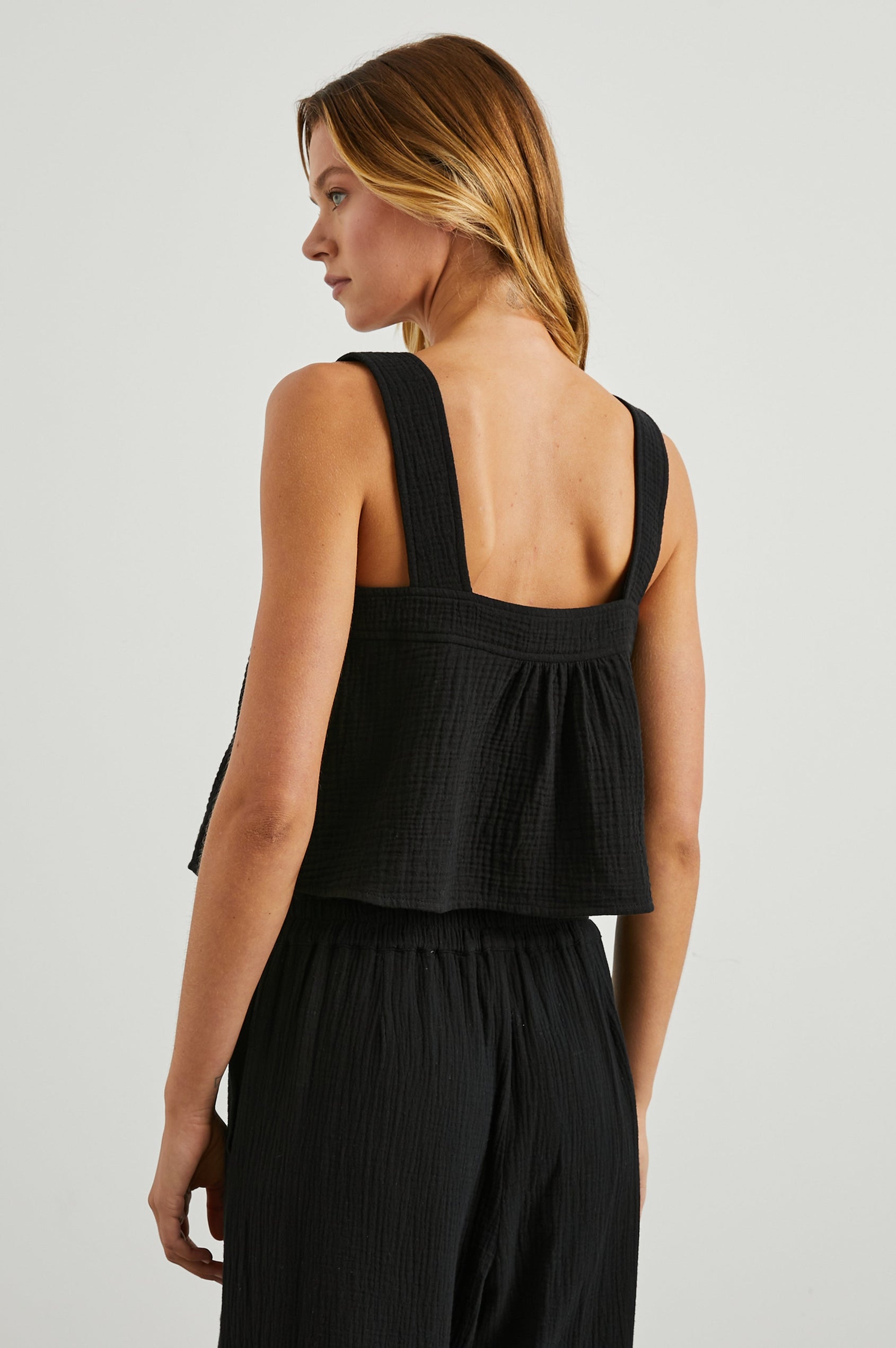 Enya Cropped Tank Top with a Square Neck with a V Cutout with Ties in Black Gauze Colorway - Back View Featured on Model