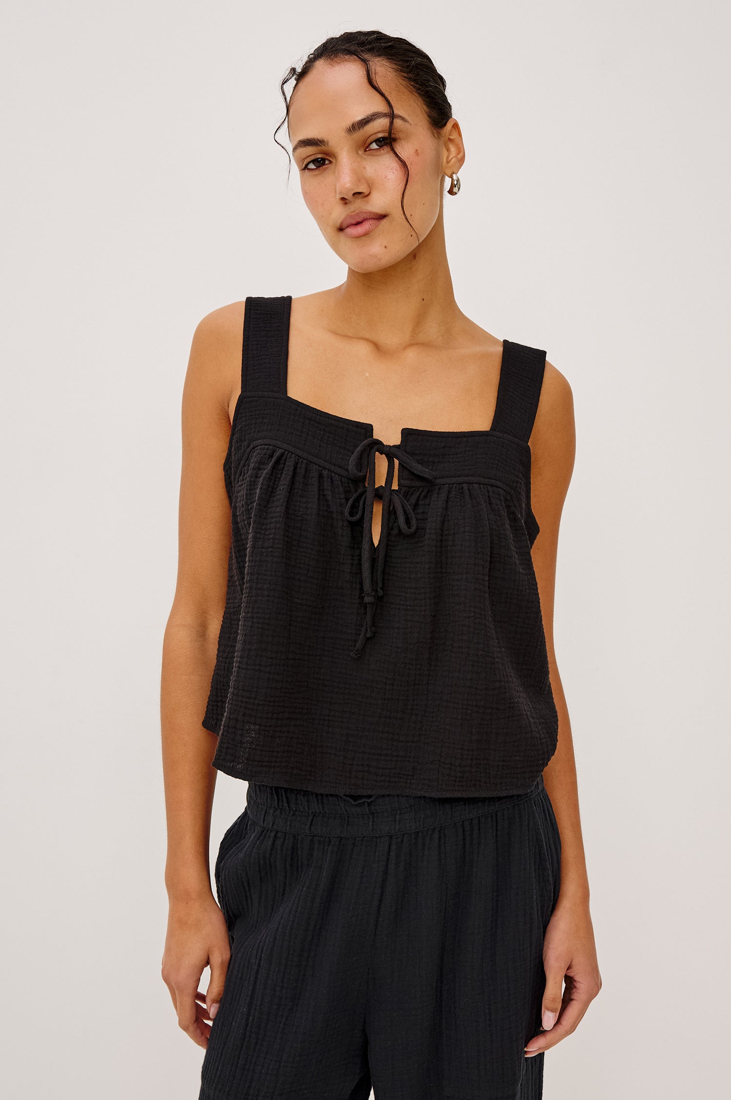 Enya Cropped Tank Top with a Square Neck with a V Cutout with Ties in Black Gauze Colorway - Front View Featured on Model