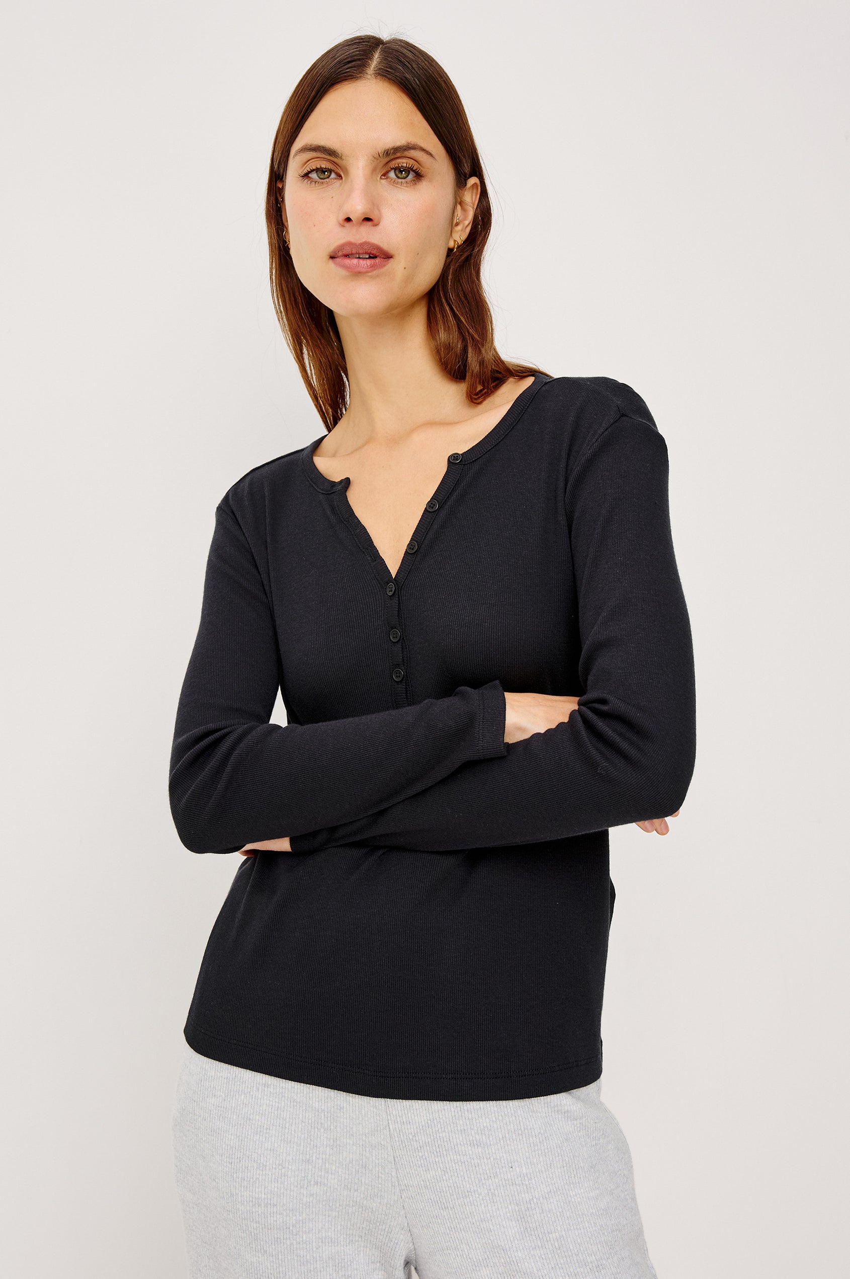Essential Ribbed Henley With Front Placket and Long Sleeves in Black Colorway - Upper Body Front View Featured on Model